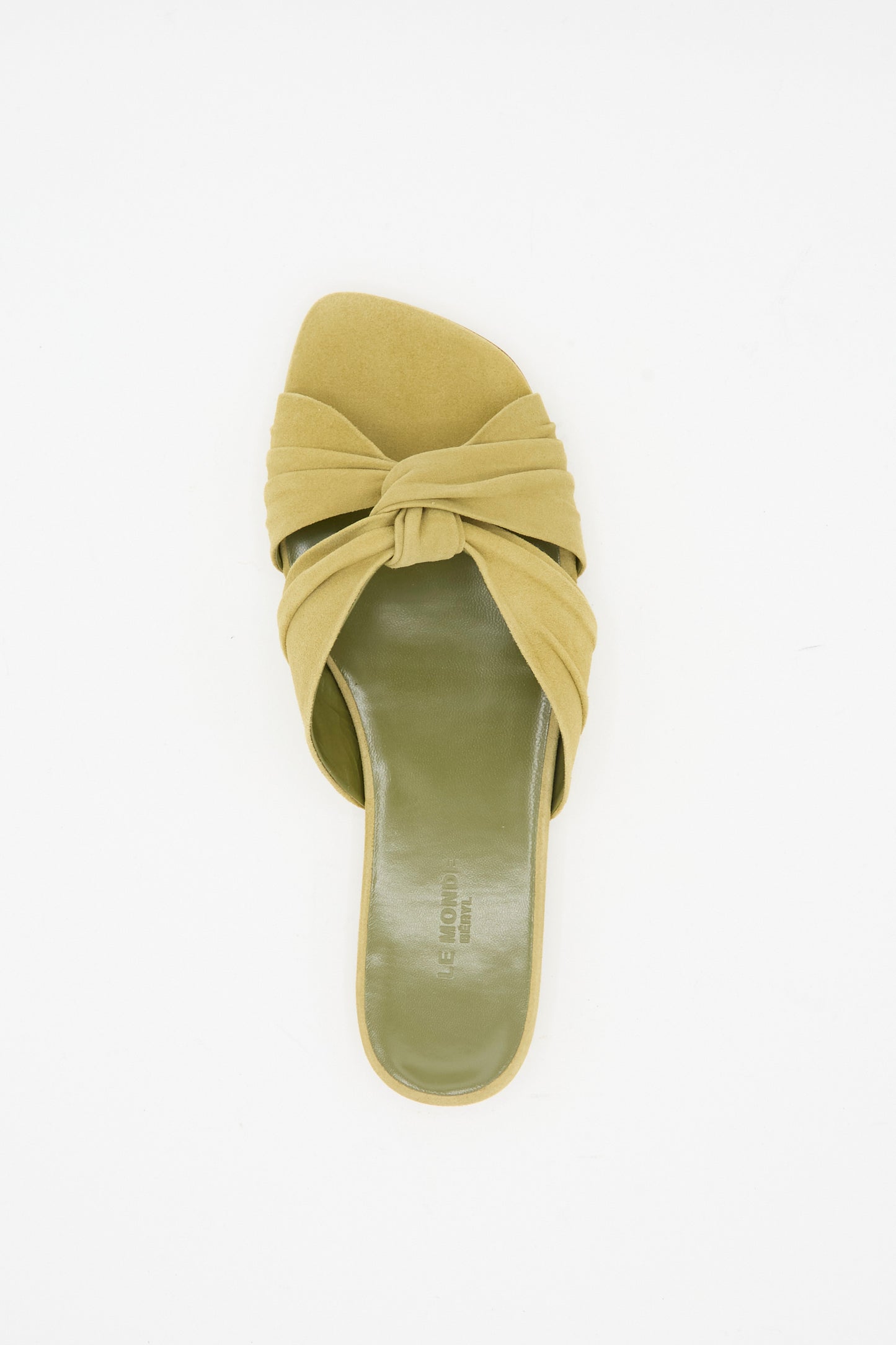 The Le Monde Beryl Antonia Flat in Grey Green is a single slide shoe with a knotted Italian suede strap and square open toe, shown from above on a white background.
