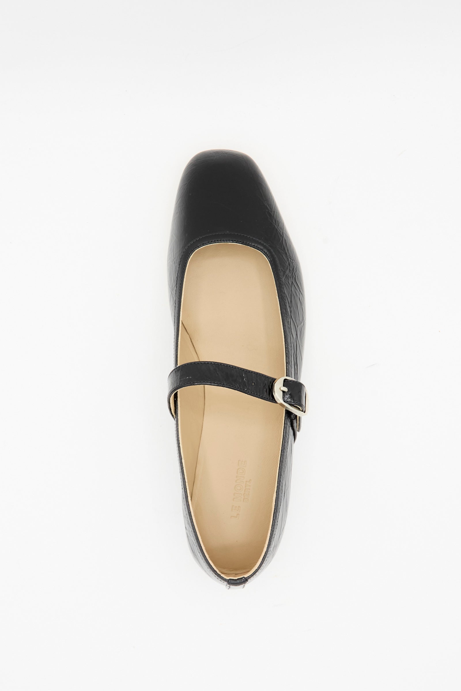 The Ballet Mary Jane in Black by Le Monde Beryl features a single lambskin leather shoe with a square toe and buckle strap, photographed from above on a white background.