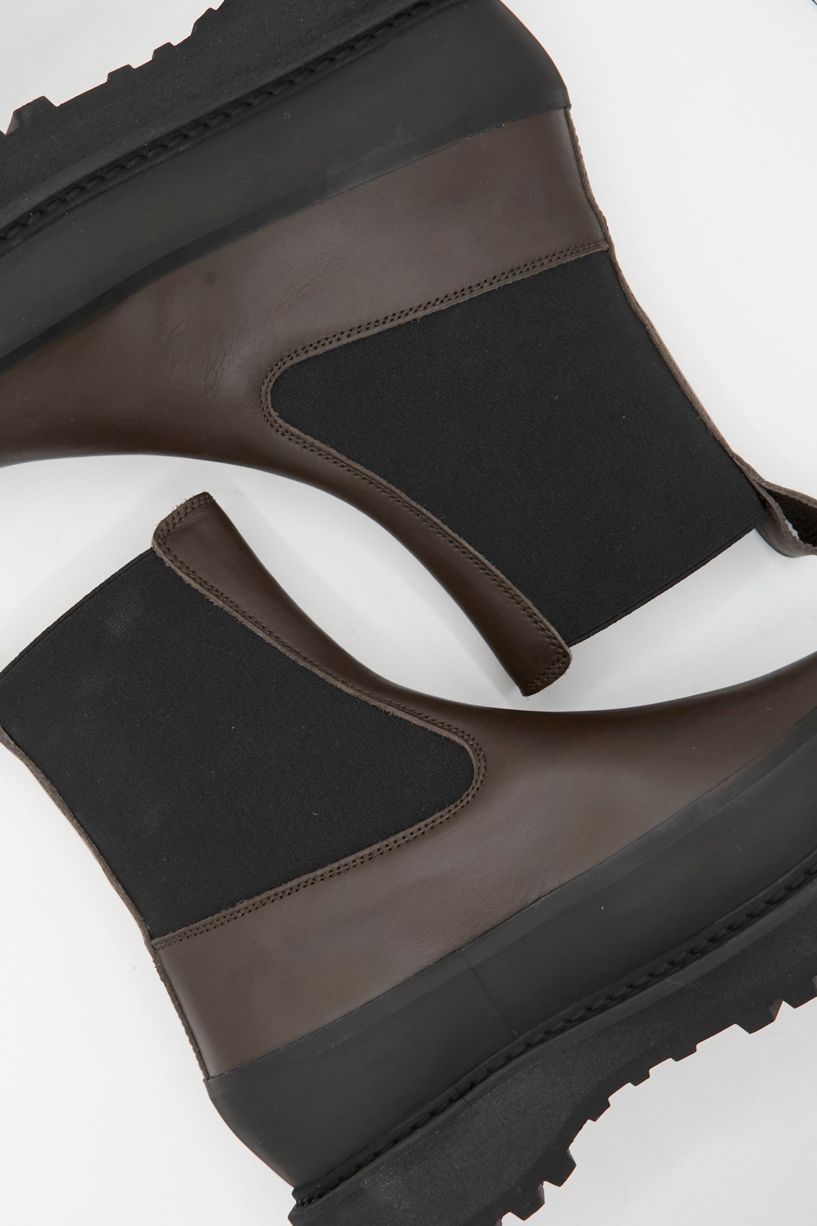 The Le Monde Beryl Chelsea Dolomite in Chocolate are dark brown calf leather Chelsea boots with chunky, ridged soles and a pull-tab, shown from above against a white background.