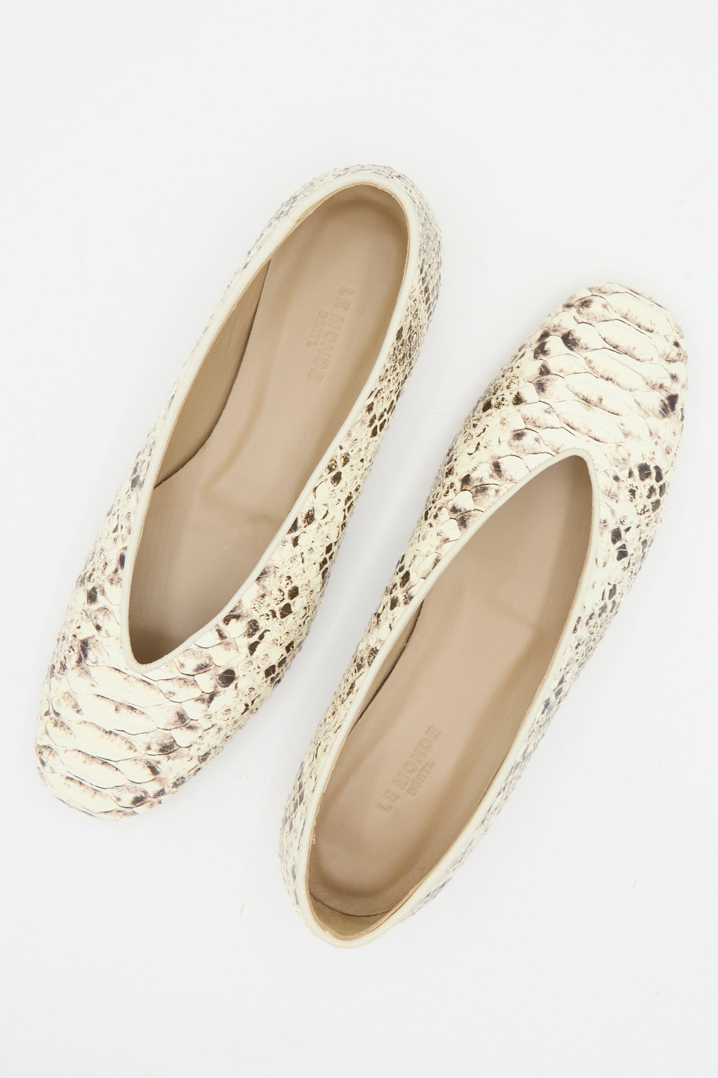 A pair of Le Monde Beryl Classic Regency Flat in Roccia, featuring beige and brown snake-embossed leather with rounded toes, viewed from above on a white background.