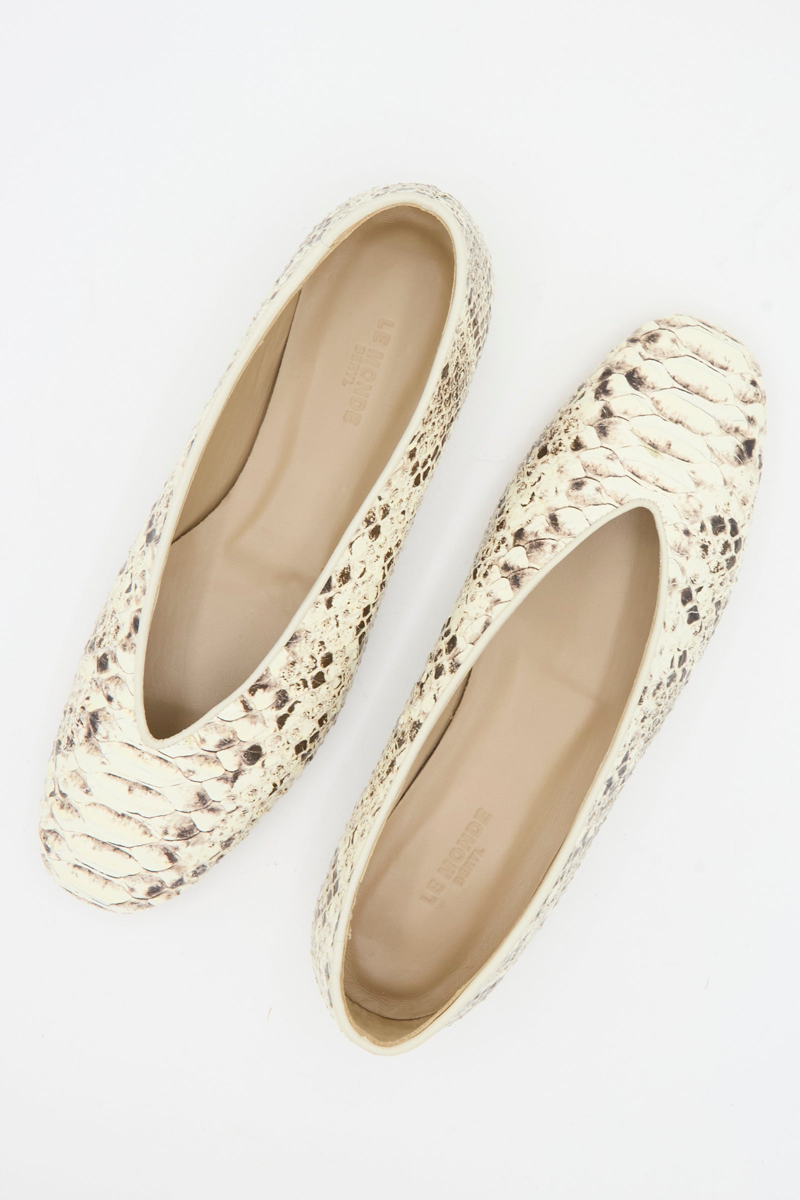 A pair of Le Monde Beryl Classic Regency Flat in Roccia, featuring beige and brown snake-embossed leather with rounded toes, viewed from above on a white background.