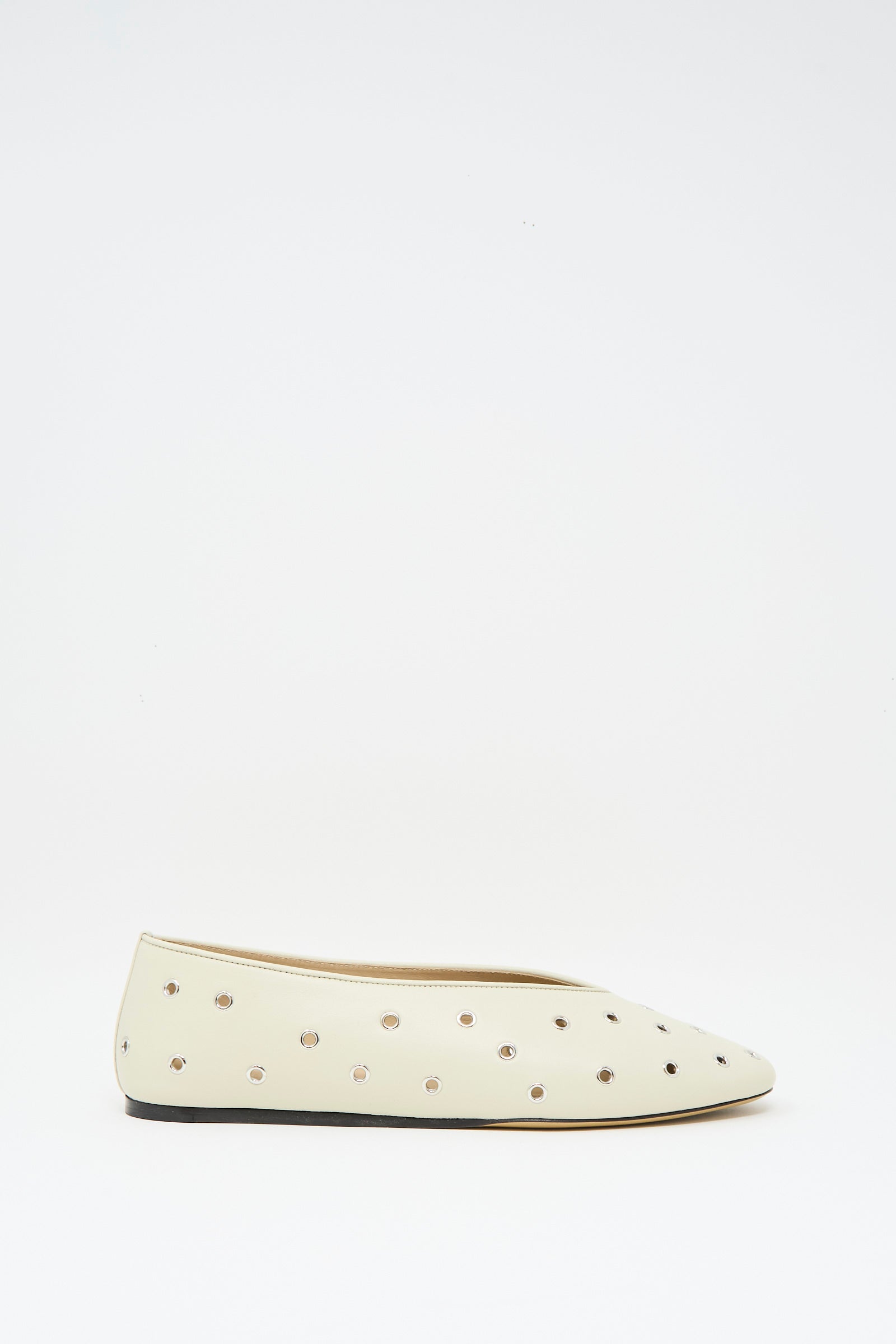 The Le Monde Beryl Eyelet Studded Leather Regency Slipper in Ecru features a pointed toe, cushioned insole, and small round metallic studs, shown against a plain white background.