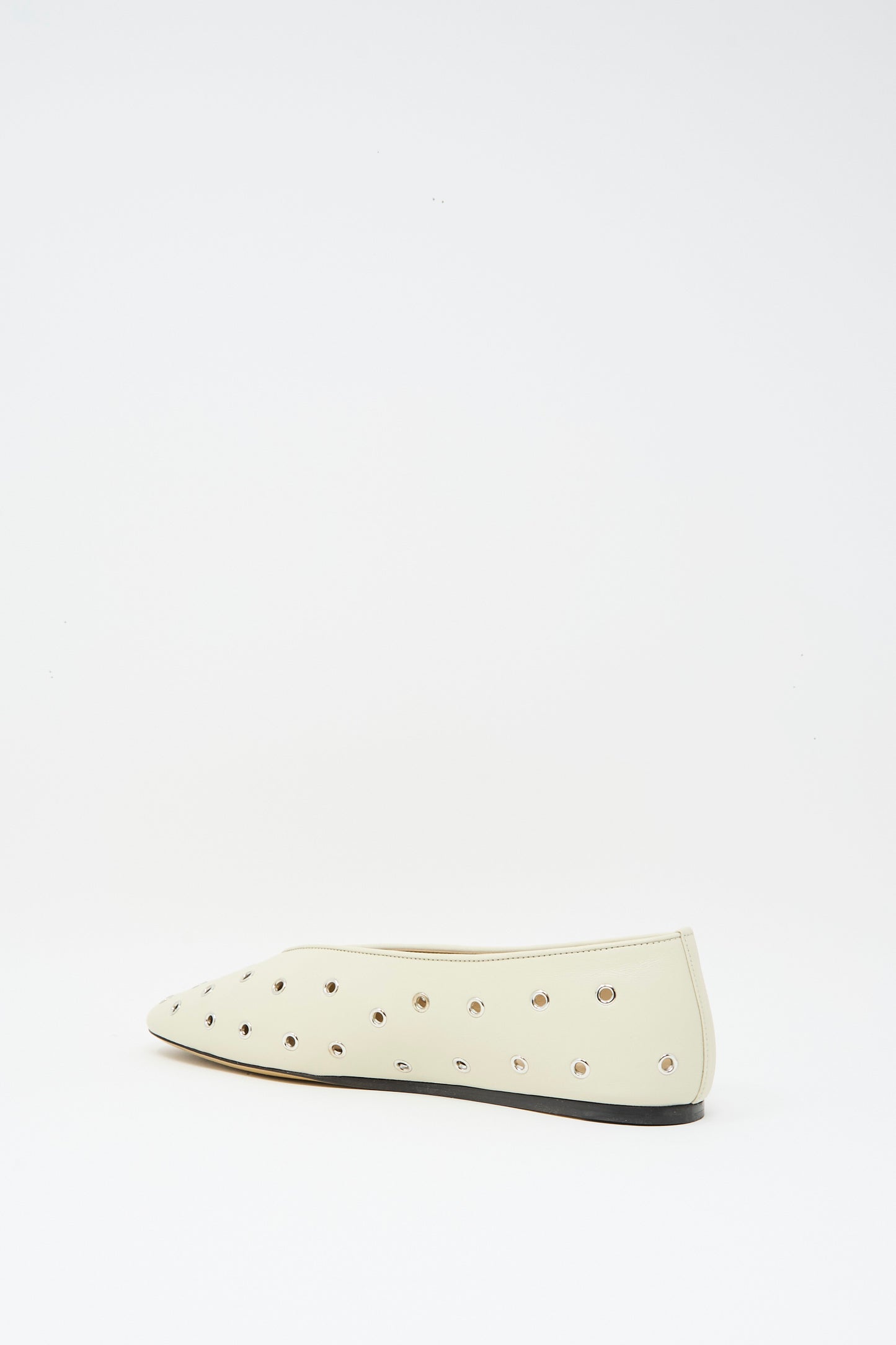 The Le Monde Beryl Eyelet Studded Leather Regency Slipper in Ecru features metallic eyelets and a cushioned insole, shown on a white background.