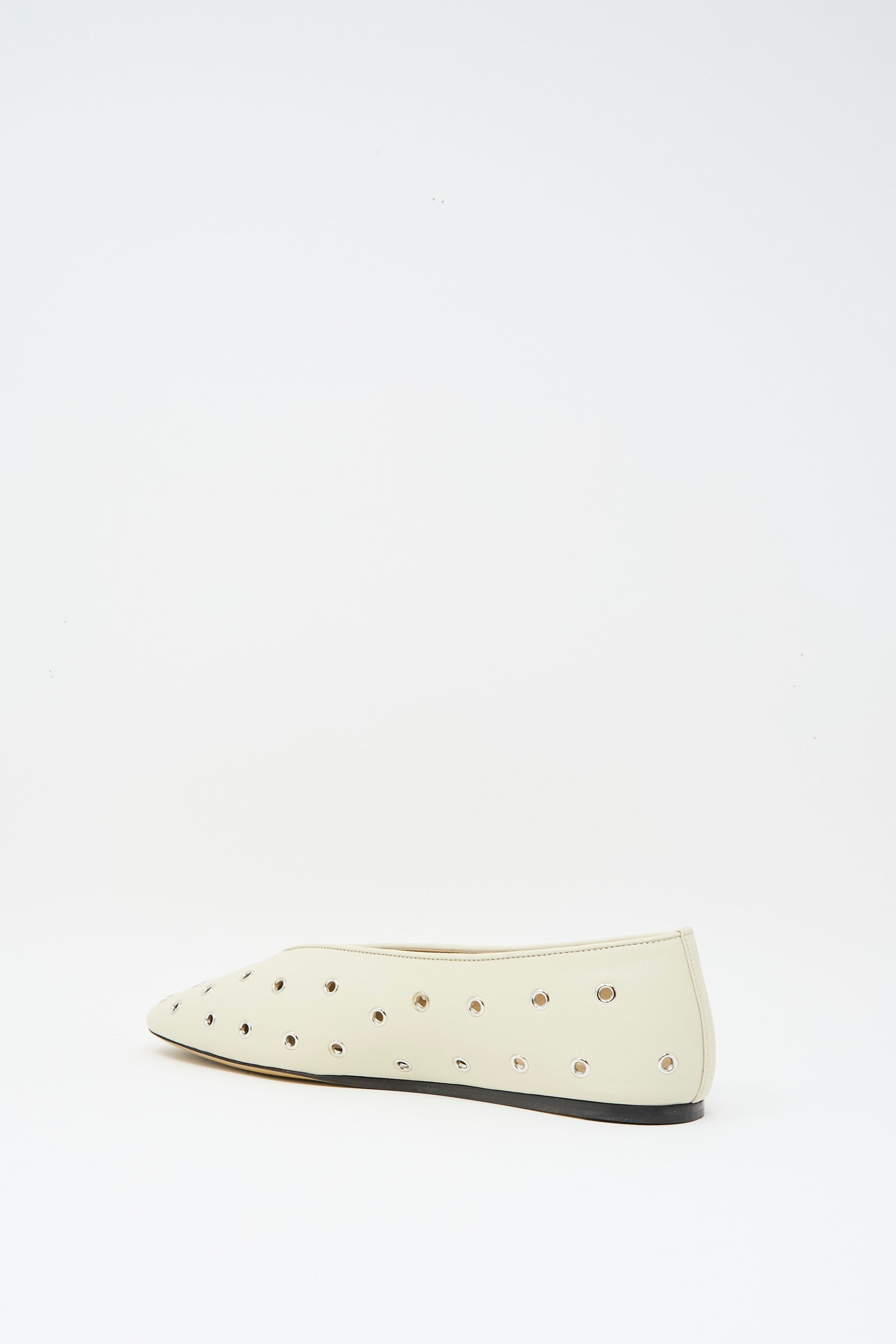 The Le Monde Beryl Eyelet Studded Leather Regency Slipper in Ecru features metallic eyelets and a cushioned insole, shown on a white background.