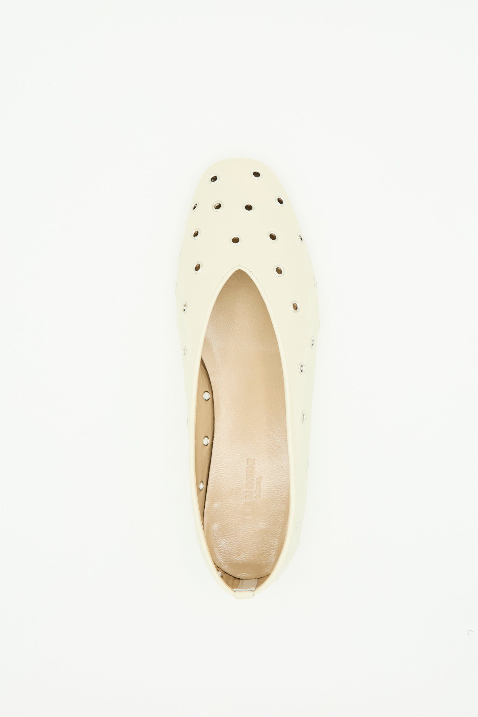The Le Monde Beryl Eyelet Studded Leather Regency Slipper in Ecru is shown from above, featuring a rounded toe and multiple small circular cutouts on the upper, plus a cushioned insole for comfort.