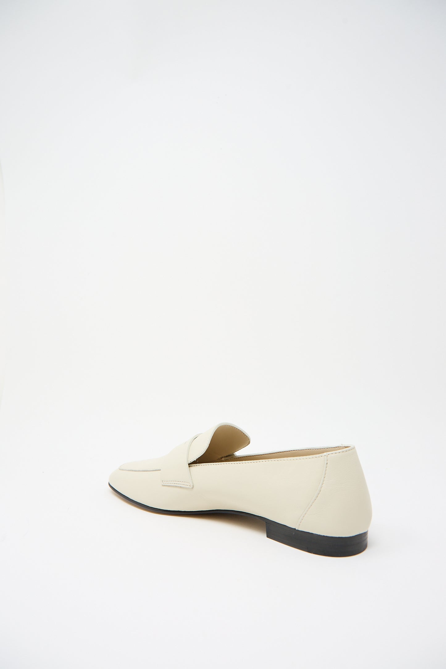 A single beige "Soft Loafer with Placket in Ecru" by Le Monde Beryl with a flat black sole and cushioned insole, viewed from the side on a plain white background.