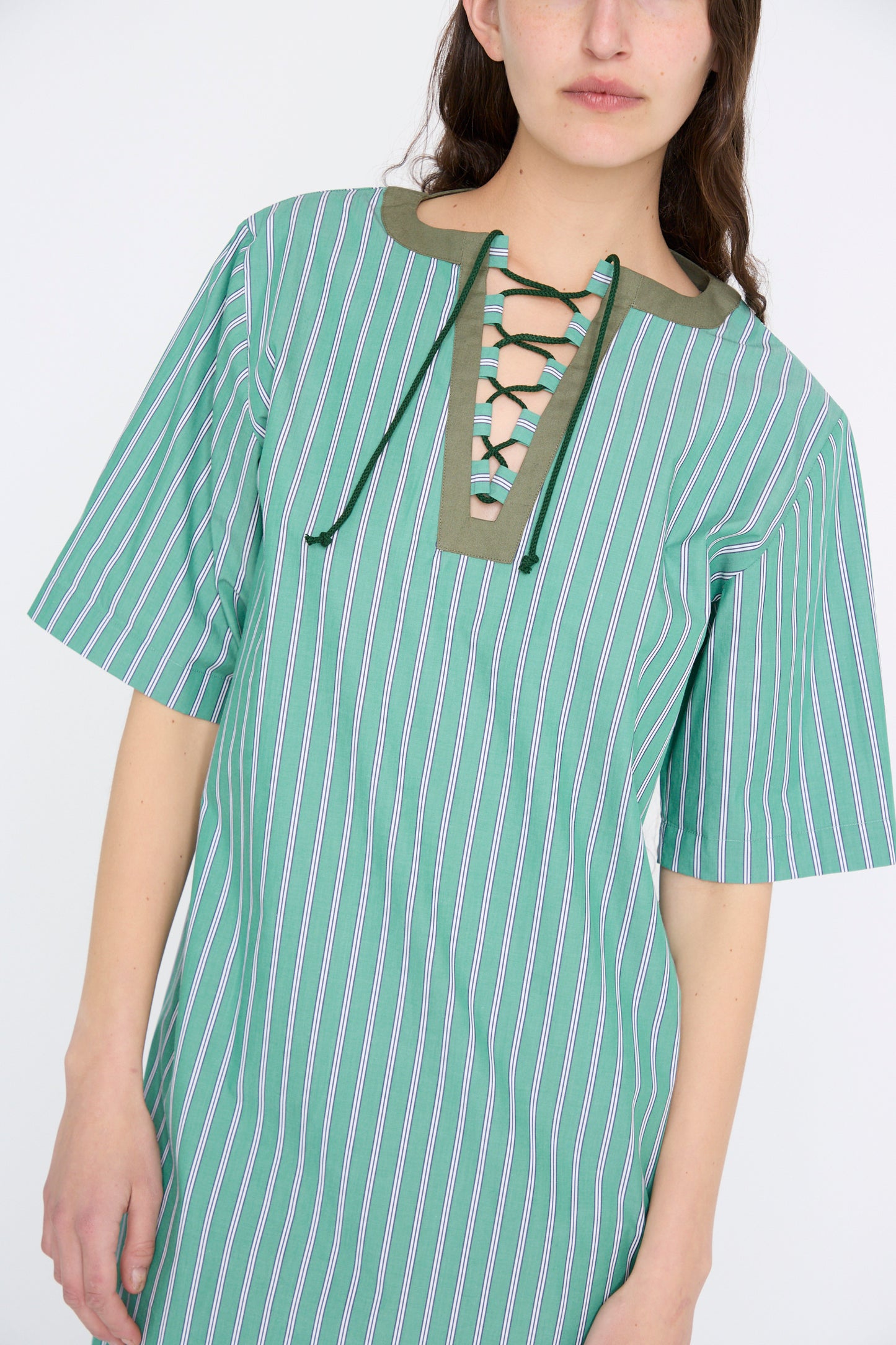 The Robe Giulia in Menthe by Les Prairies De Paris features green stripes and a lace-up string tie neckline.