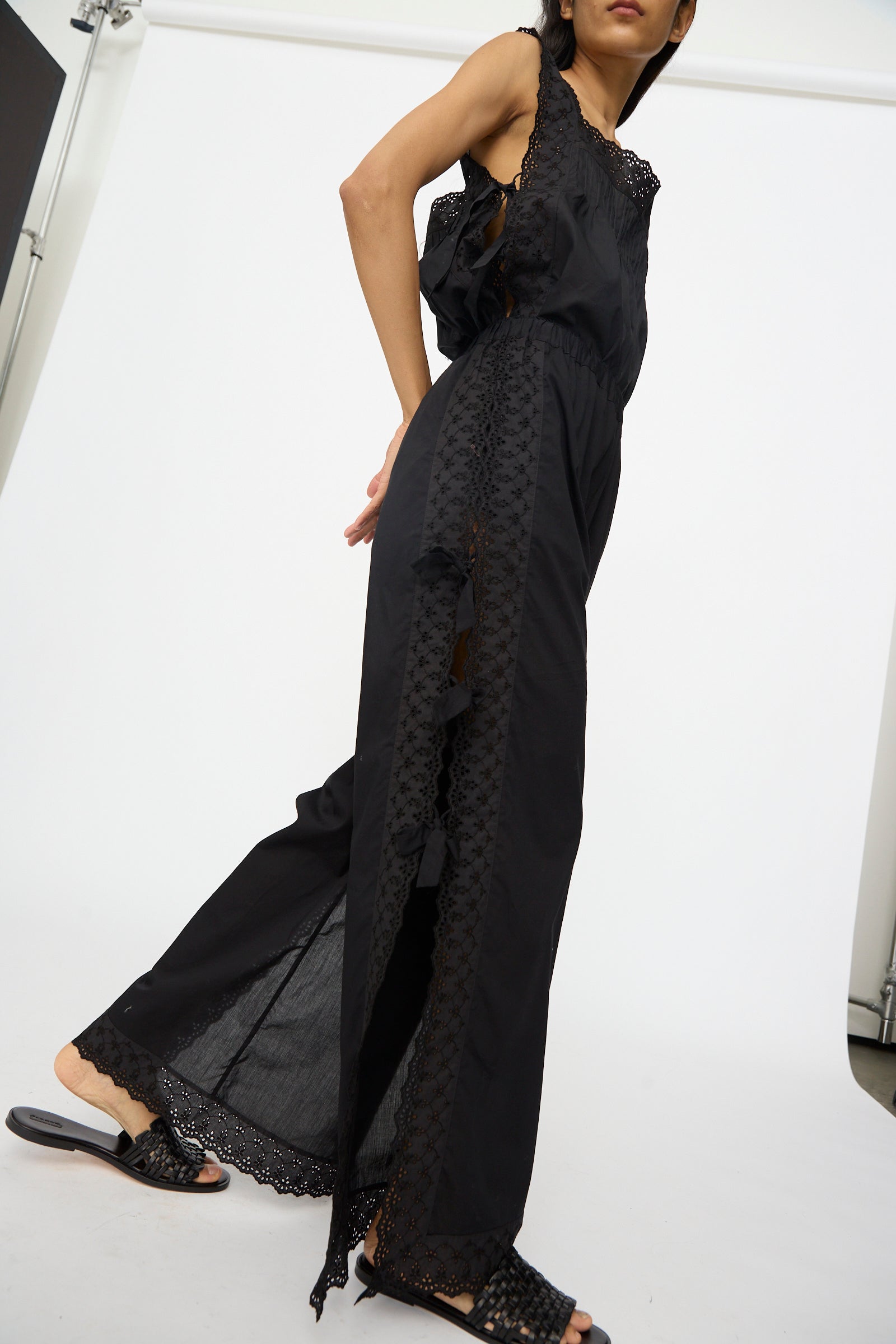 Wearing Clarissa Trousers in Nero by Loretta Caponi, this look channels timeless Italian elegance, with sleek black tailoring and classic style against a crisp white backdrop.