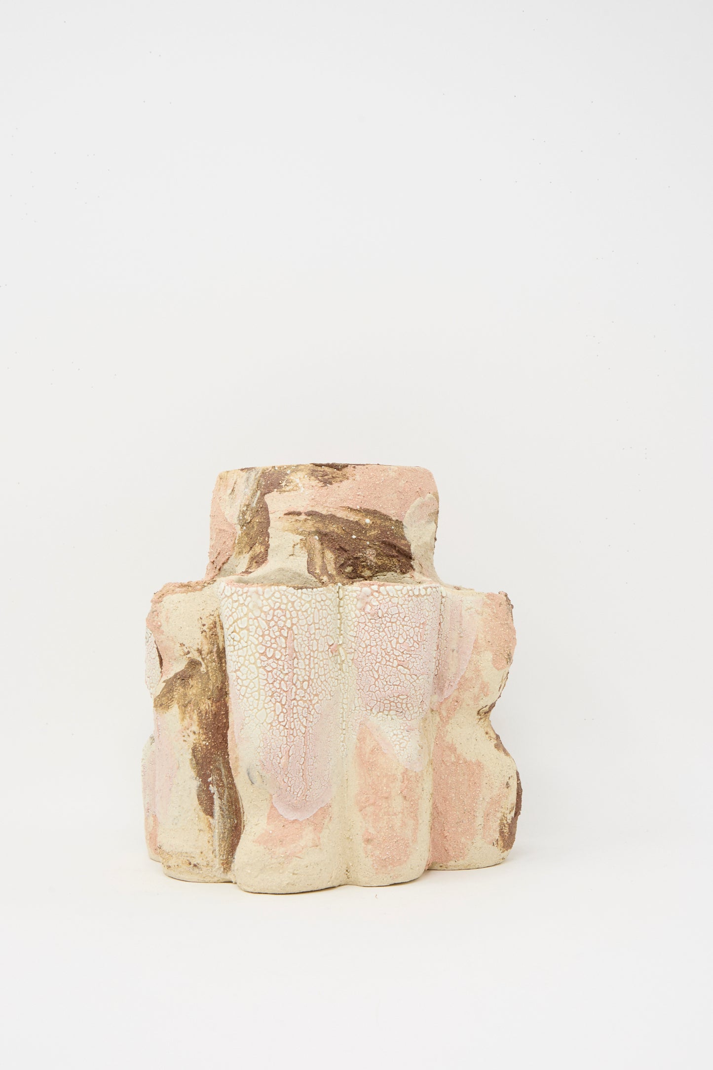 The Hand Built Clay Tulipiere Vessel by Lost Quarry features a textured, blocky ceramic design in pink, brown, and white tones, displayed against a plain white background.