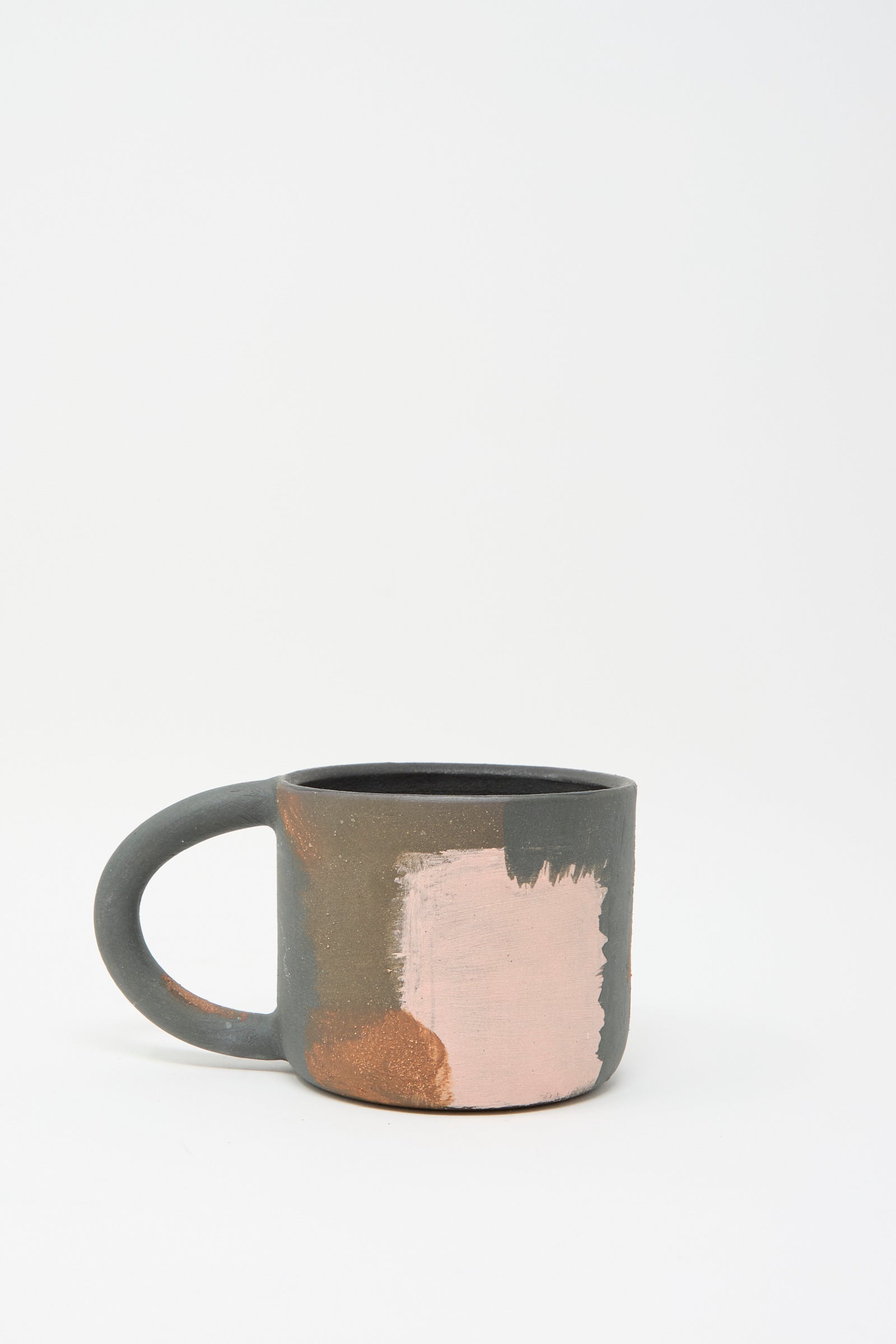 The "Hand Built Mugs in Brown Multi" by Lost Quarry are handmade ceramic mugs featuring oversized handles, a mottled texture in dark gray with light pink patches, against a plain white background.