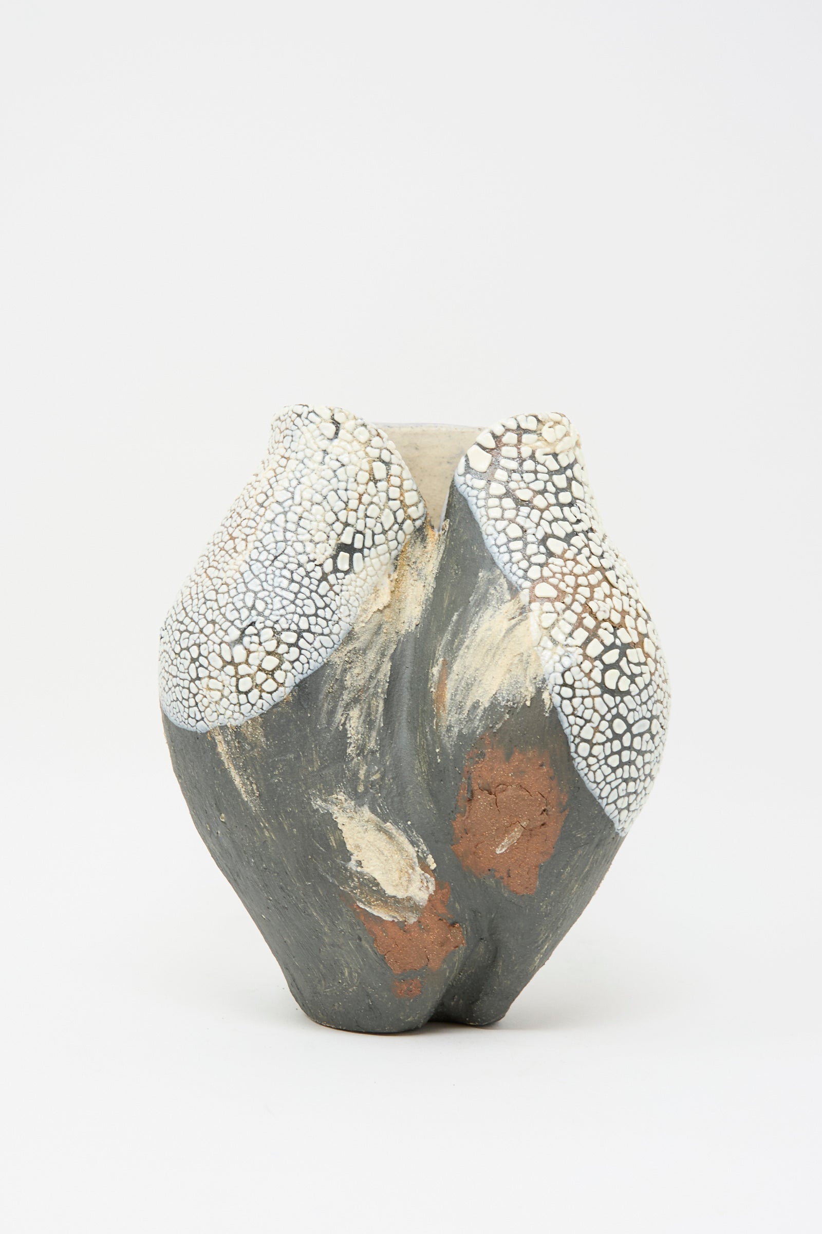 The Hand Built Textured Vessel in Black Multi by Lost Quarry is a sculptural clay vase with a 3D organic design, featuring textured glaze in gray, white crackle, and earthy red-brown tones set against a plain white background.