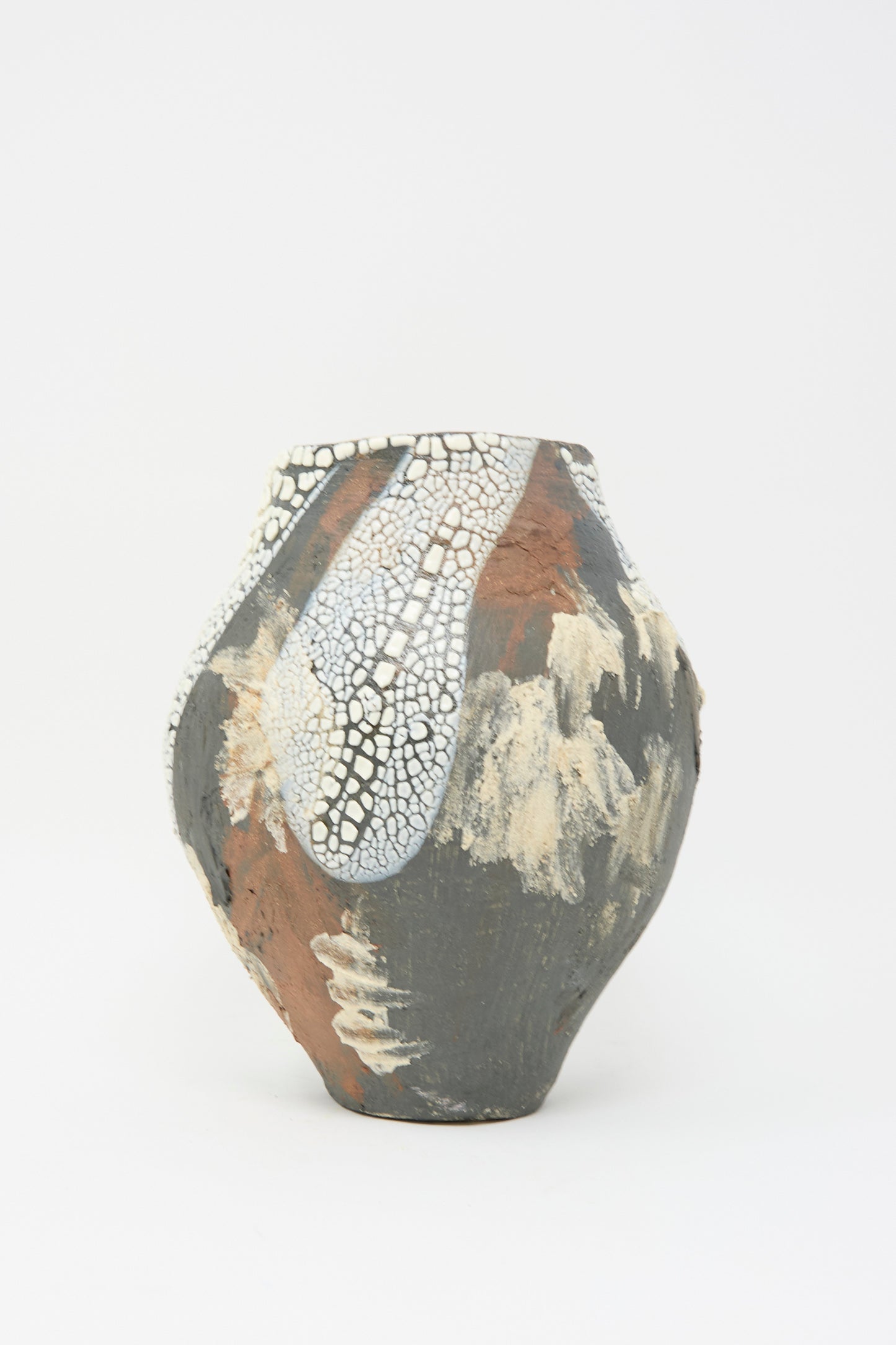 The "Hand Built Textured Vessel in Black Multi" by Lost Quarry is a decorative ceramic piece with an abstract design, featuring brown, black, and white tones alongside crackled textures on its smooth surface.