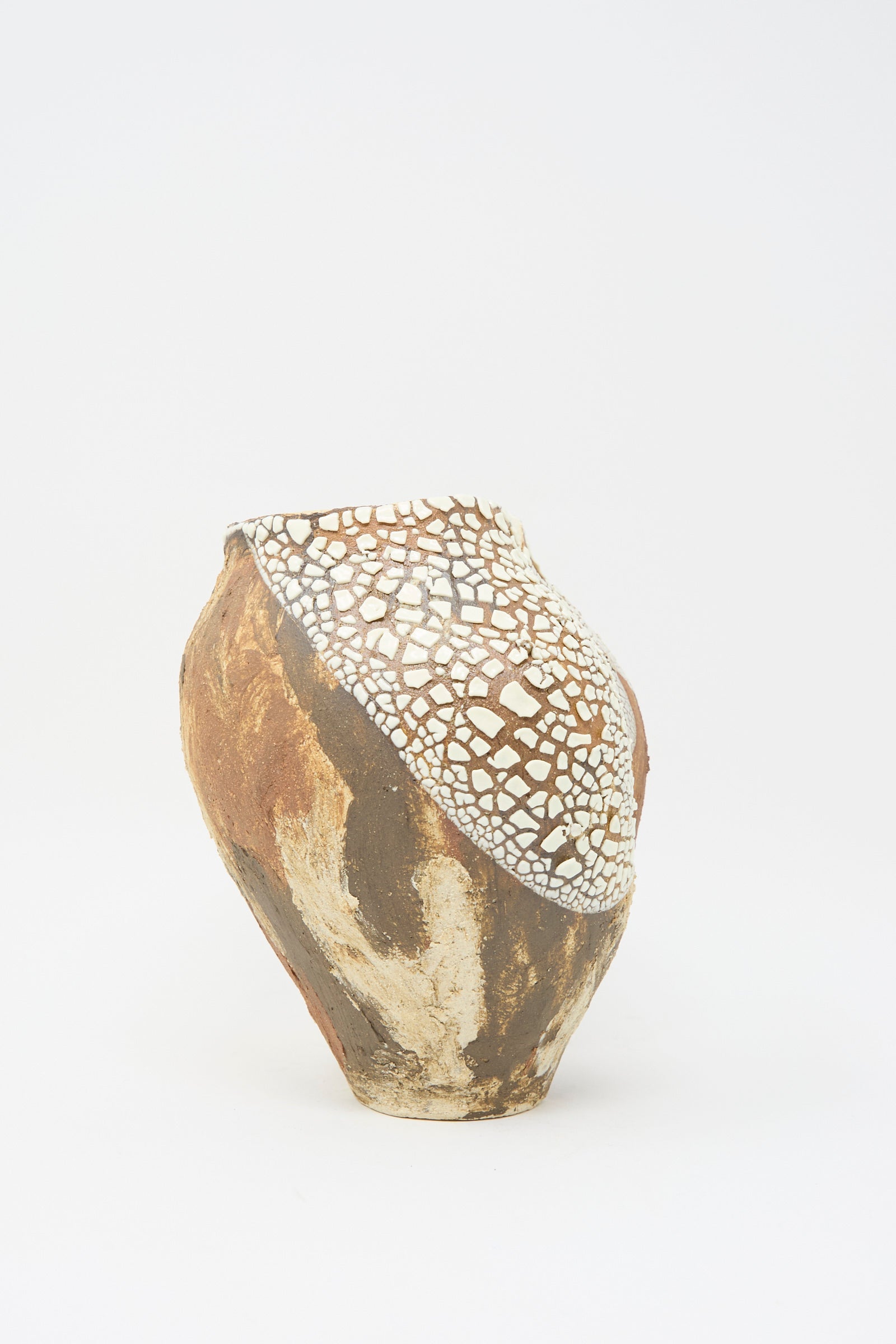 The "Hand Built Textured Vessel in Terracotta Mix" by Lost Quarry is a ceramic piece with an irregular shape, showcasing a textured glaze and cracked white pattern on top, contrasted by rustic brown tones on the bottom, against a plain white background.