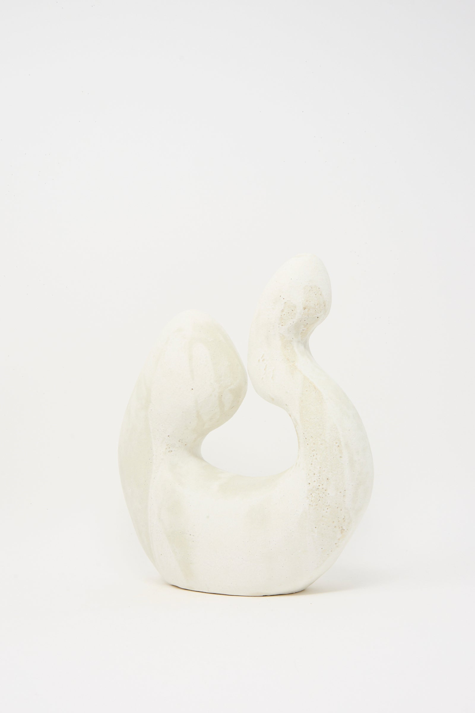 Hand Built Vessel No. 000980 by Lost Quarry is a white ceramic sculpture featuring smooth, curved shapes and a subtle textured finish, displayed against a plain white background.