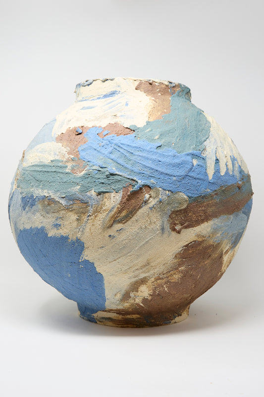 The Hand Built Waves Vessel by Lost Quarry is a handmade round ceramic piece with a textured surface and abstract blue, cream, and brown brushstrokes—crafted in Brooklyn.