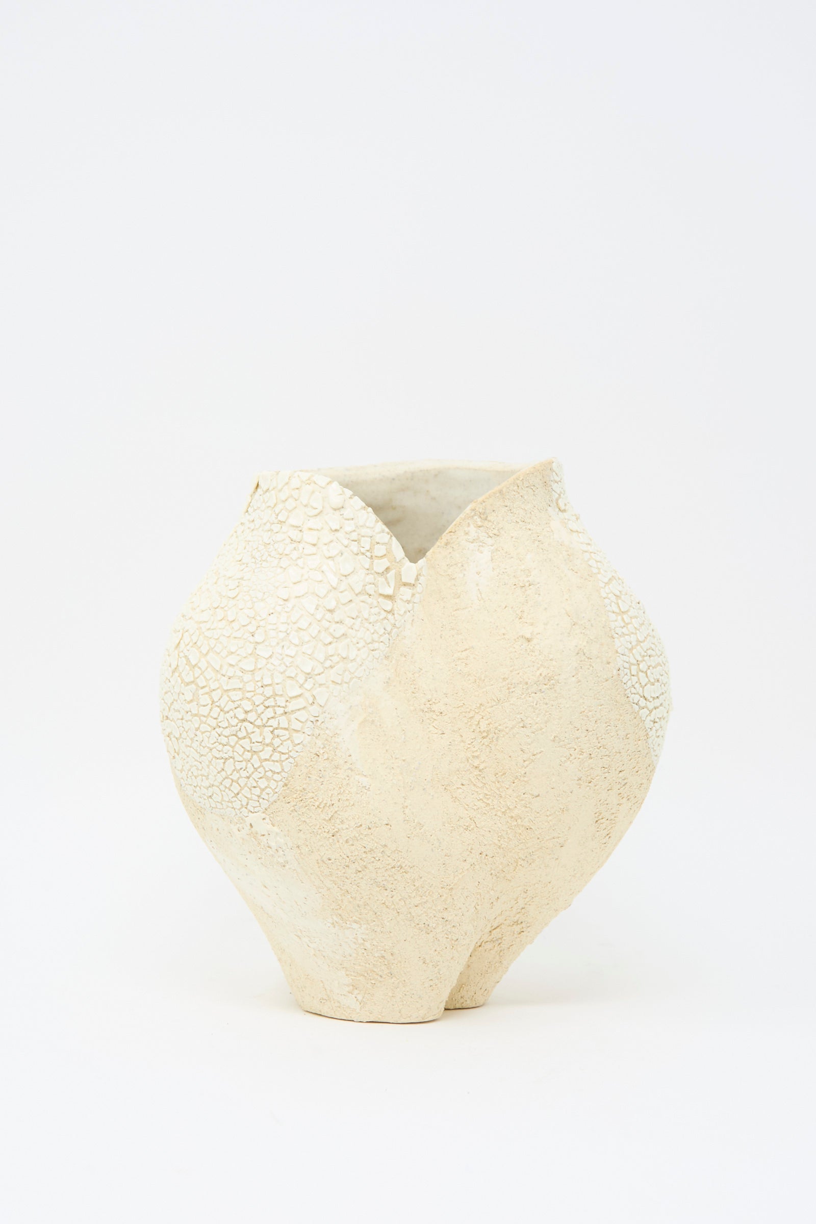 The Hand Built Textured Vessel in Neutral and White from Lost Quarry features an organic clay design in light beige, set against a plain white background.