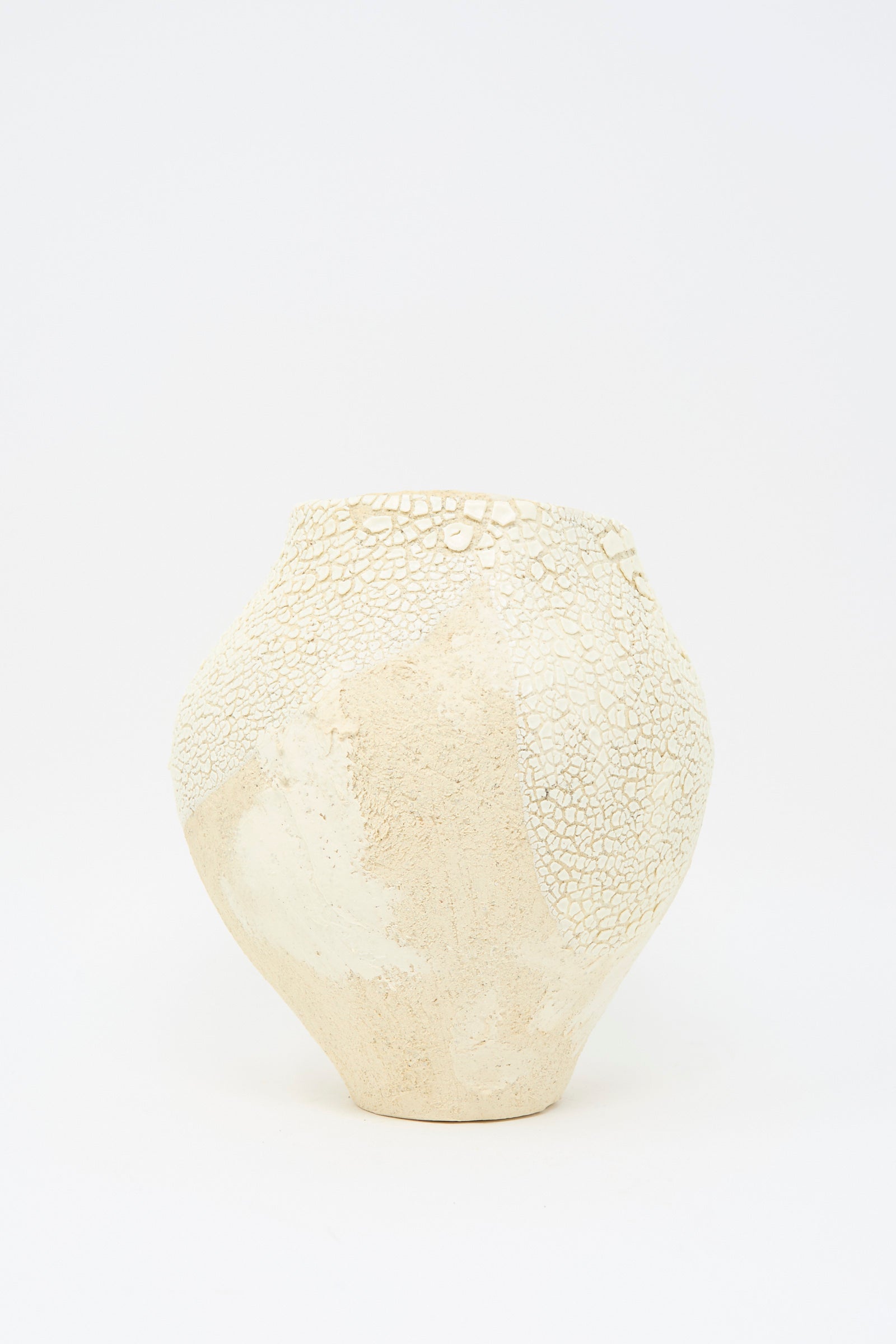 A Lost Quarry "Hand Built Textured Vessel in Neutral and White" features a sculptural ceramic design with a textured glaze and cracked, uneven surface against a plain white background.