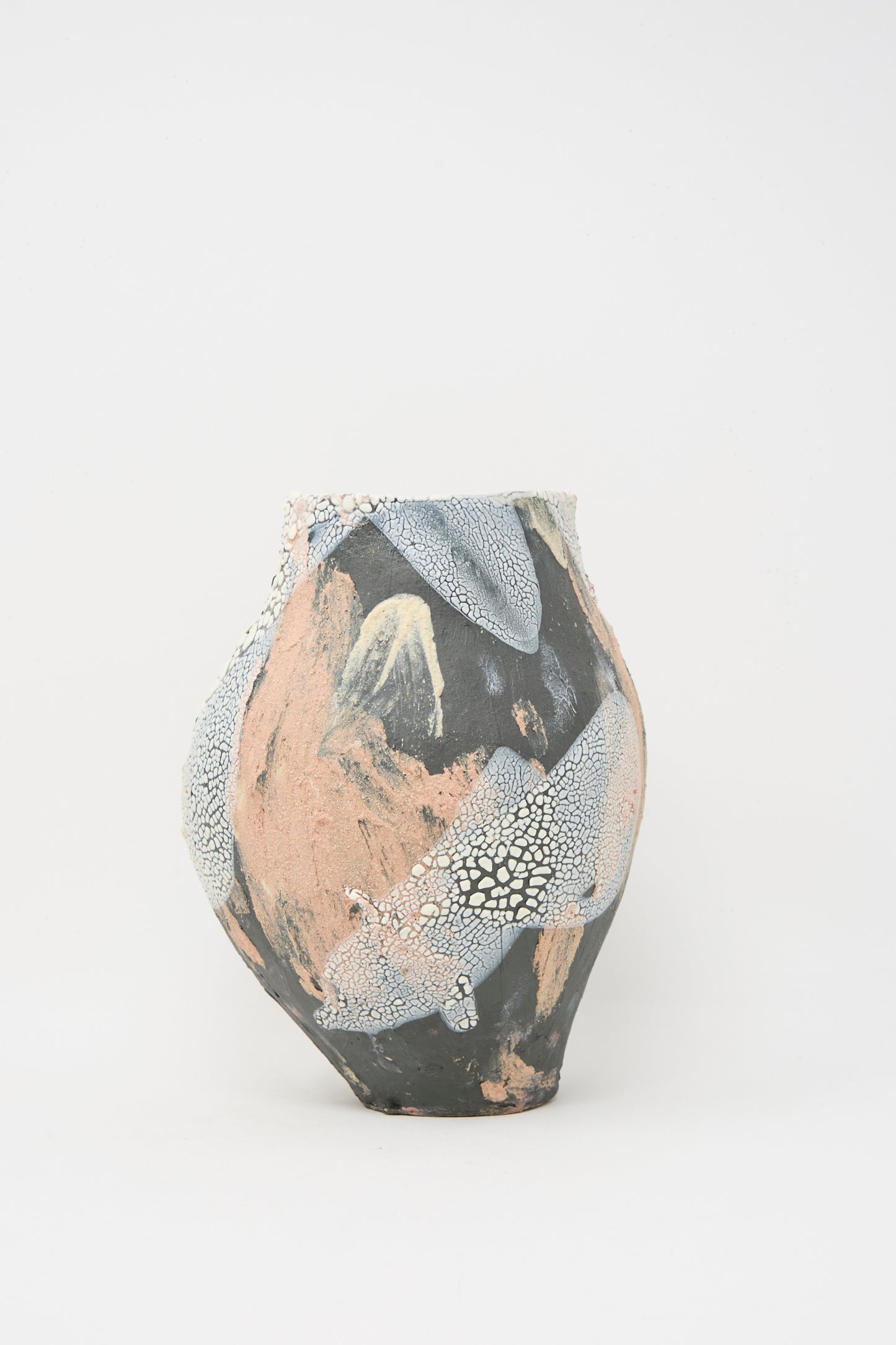 The Medium Hand Built Textured Vessel in Black Pink Multi by Lost Quarry is a hand-built ceramic piece with a rounded shape, finished in matte peach, black, and textured white glaze on a plain white background.