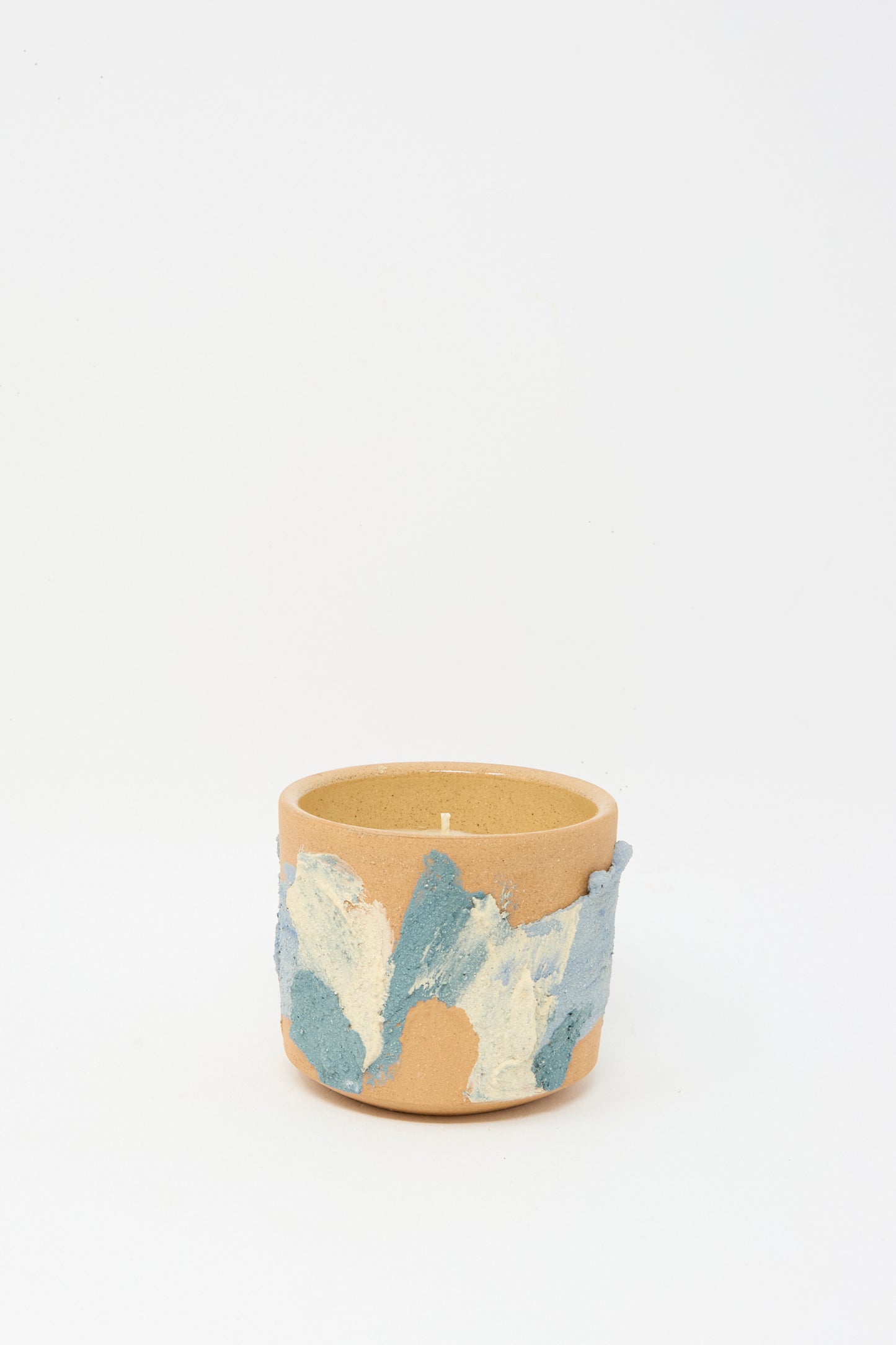 The Neroli Candle in Blue Terracotta by Lost Quarry features a round beige coconut–soy blend candle in a hand-built ceramic vessel with blue and white textured abstract patterns, shown against a plain white background.
