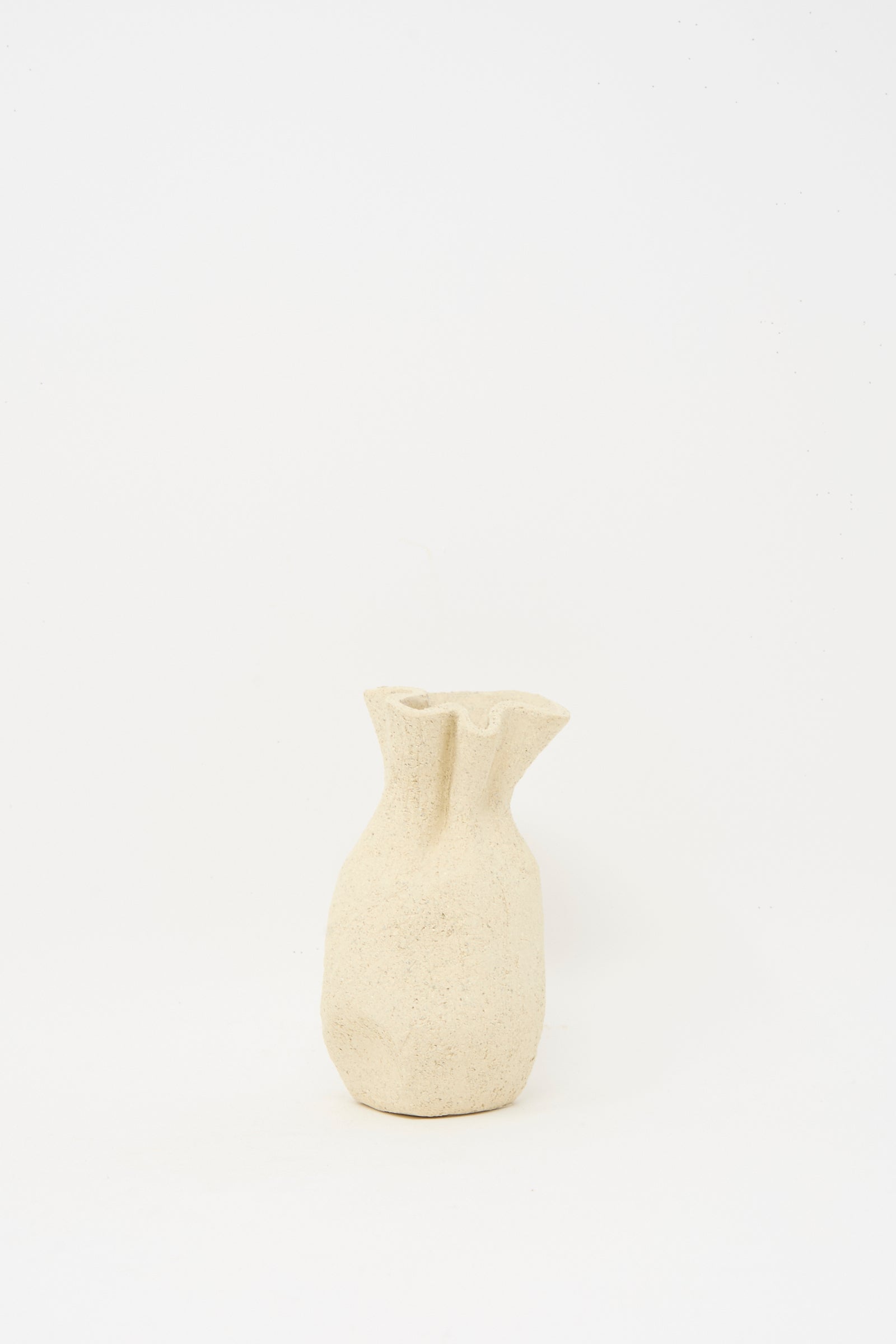 The Textured Clay Folded Vessel III by Lost Quarry is a small, handmade beige ceramic vase with an irregular shape and textured surface, ideal for unique floral arrangements, shown against a plain white background.