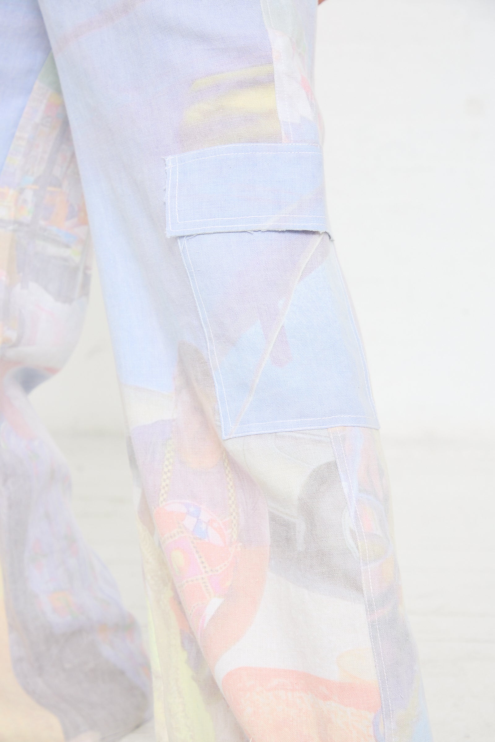 A woman wearing a pair of Luna Del Pinal Hemp Cargo Trousers in Oversized Digital Market Print.