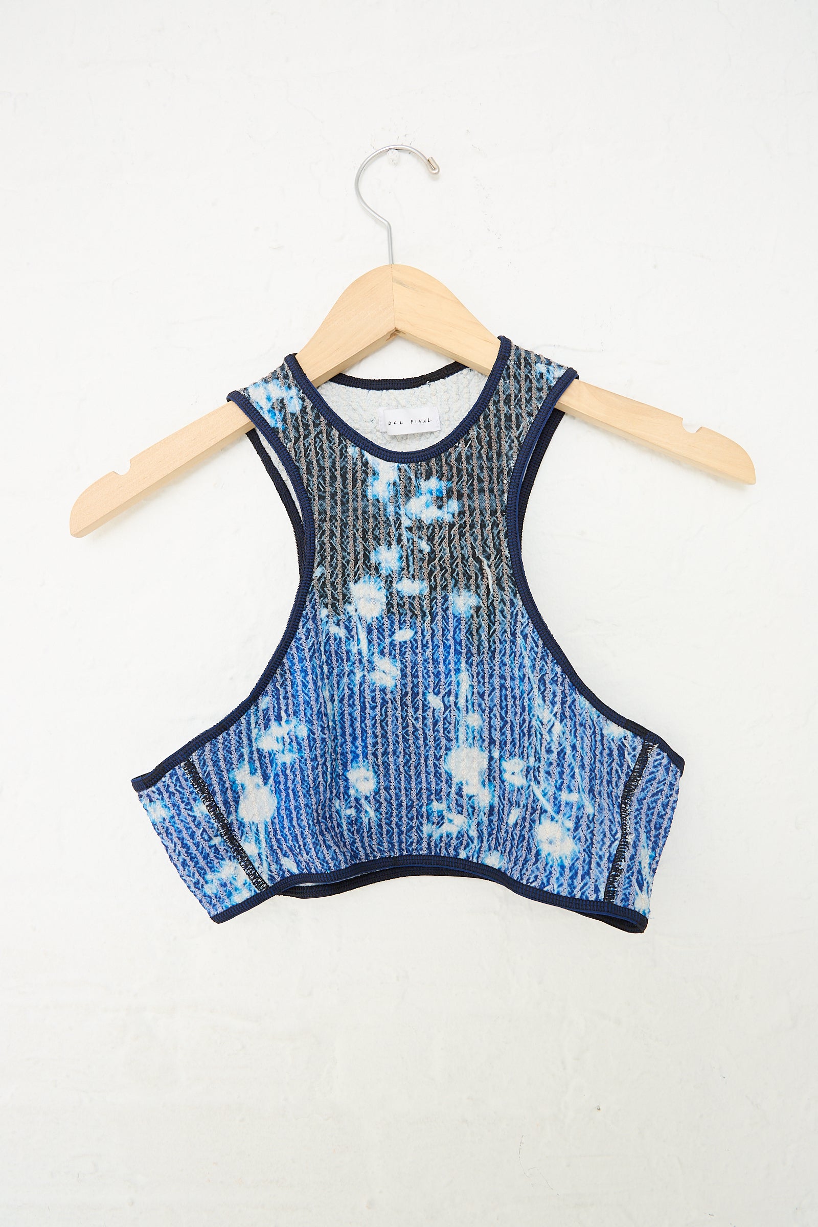 A Jasmine Screen Printed Stretch Weave Crop Top Bikini in Midnight Blue by Luna Del Pinal hanging on a hanger.