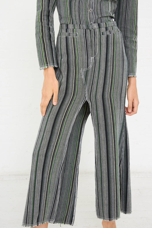 Person standing in a Tela De Raya Loom Weave Jean Skirt in Humbug Stripe by Luna Del Pinal with a hand resting on their hip against a plain white background, showcasing the chic humbug stripe pattern.