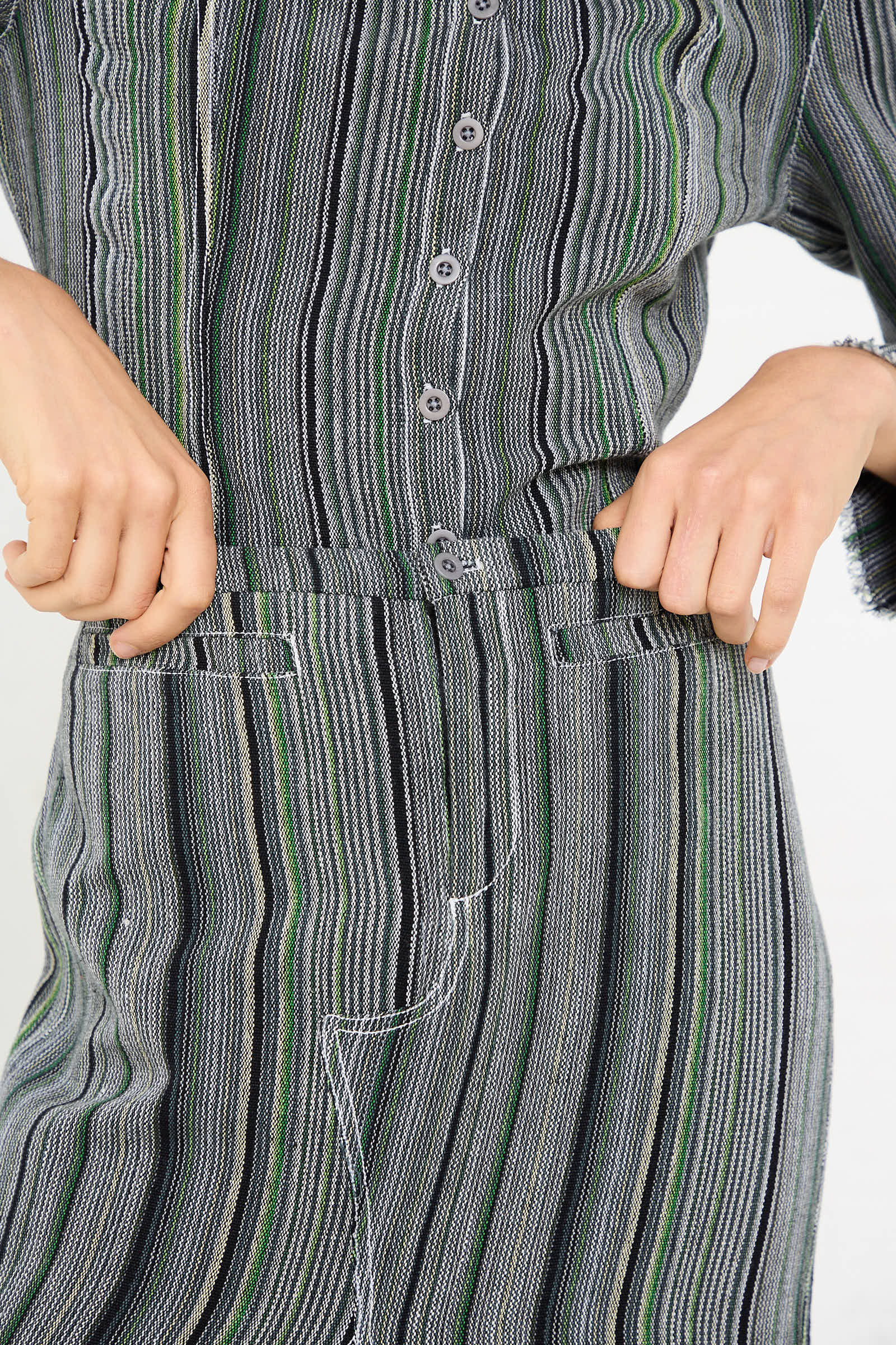 Person wearing a Tela De Raya Loom Weave Jean Skirt in Humbug Stripe by Luna Del Pinal adjusts the waistband.