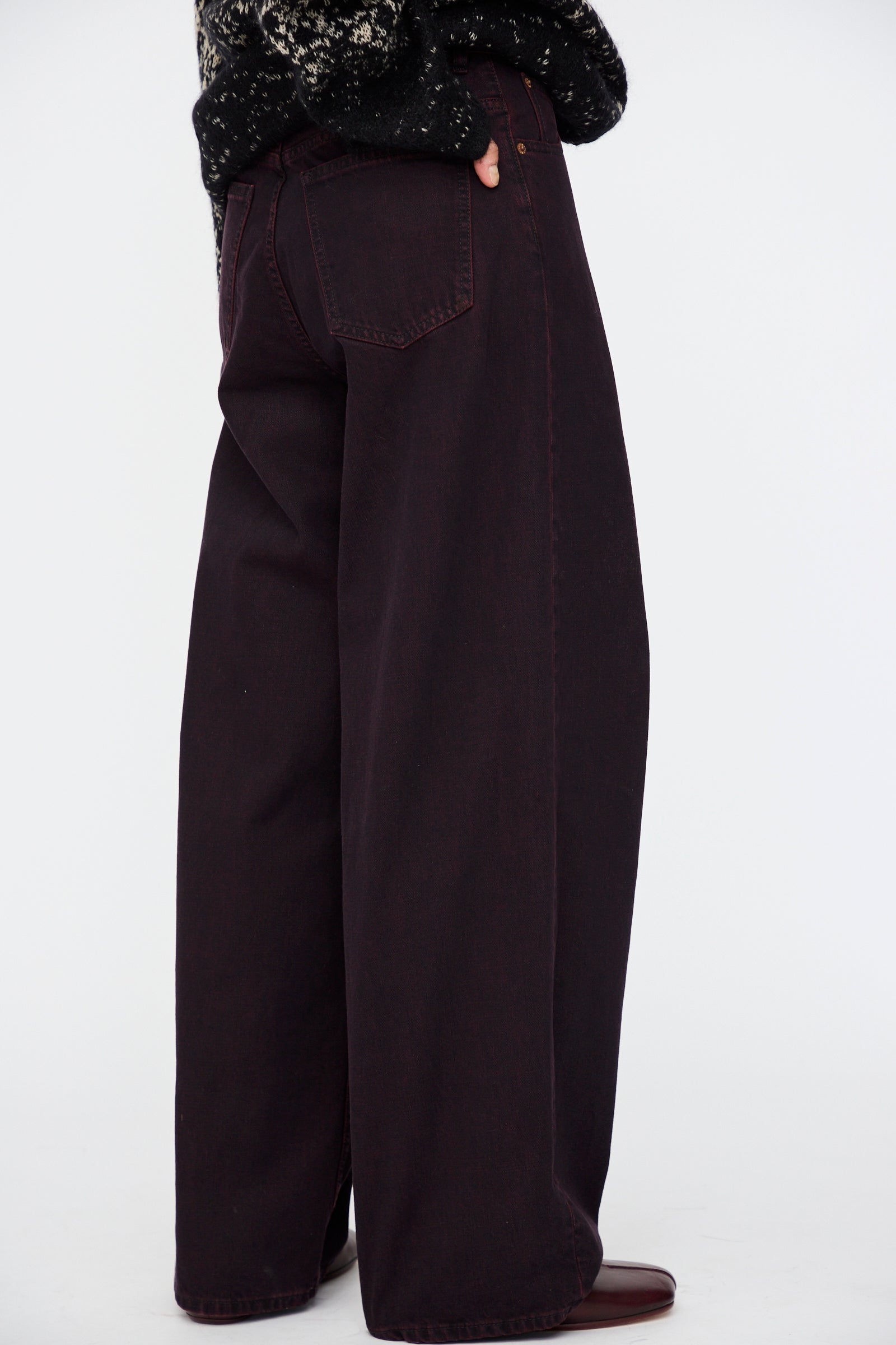 A person wearing MM6 5 Pocket Pants in Burgundy, shown from the waist down against a plain background.