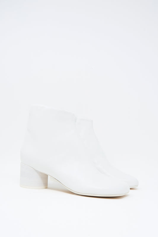 The MM6 Ankle Boot in White features buffed calfskin leather, a square toe, and a low block heel, shown against a plain white background.