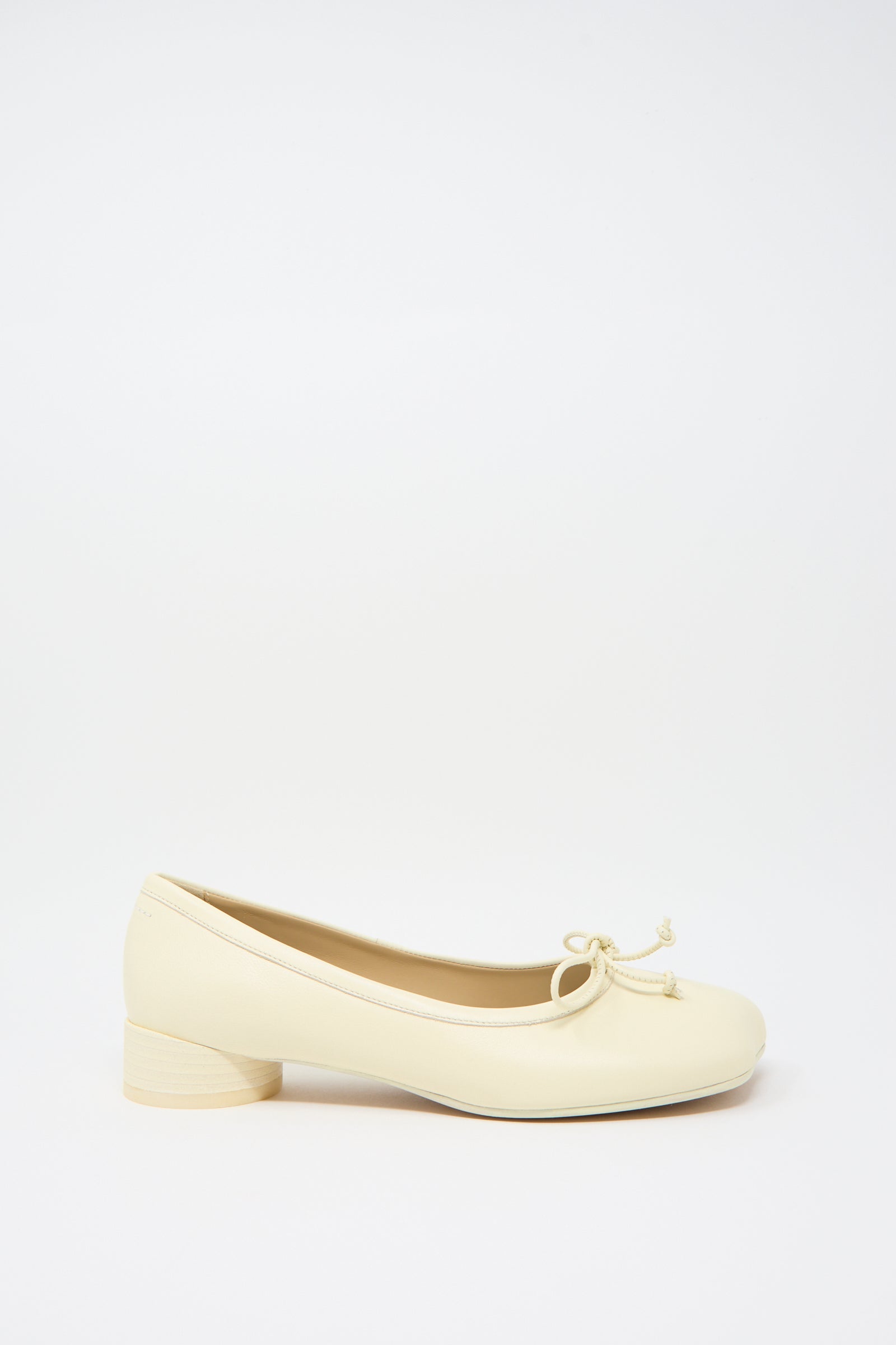 A single MM6 Ballet Shoe in Cream, crafted from beige leather, featuring a small front bow and a cylindrical heel, set against a plain white background.