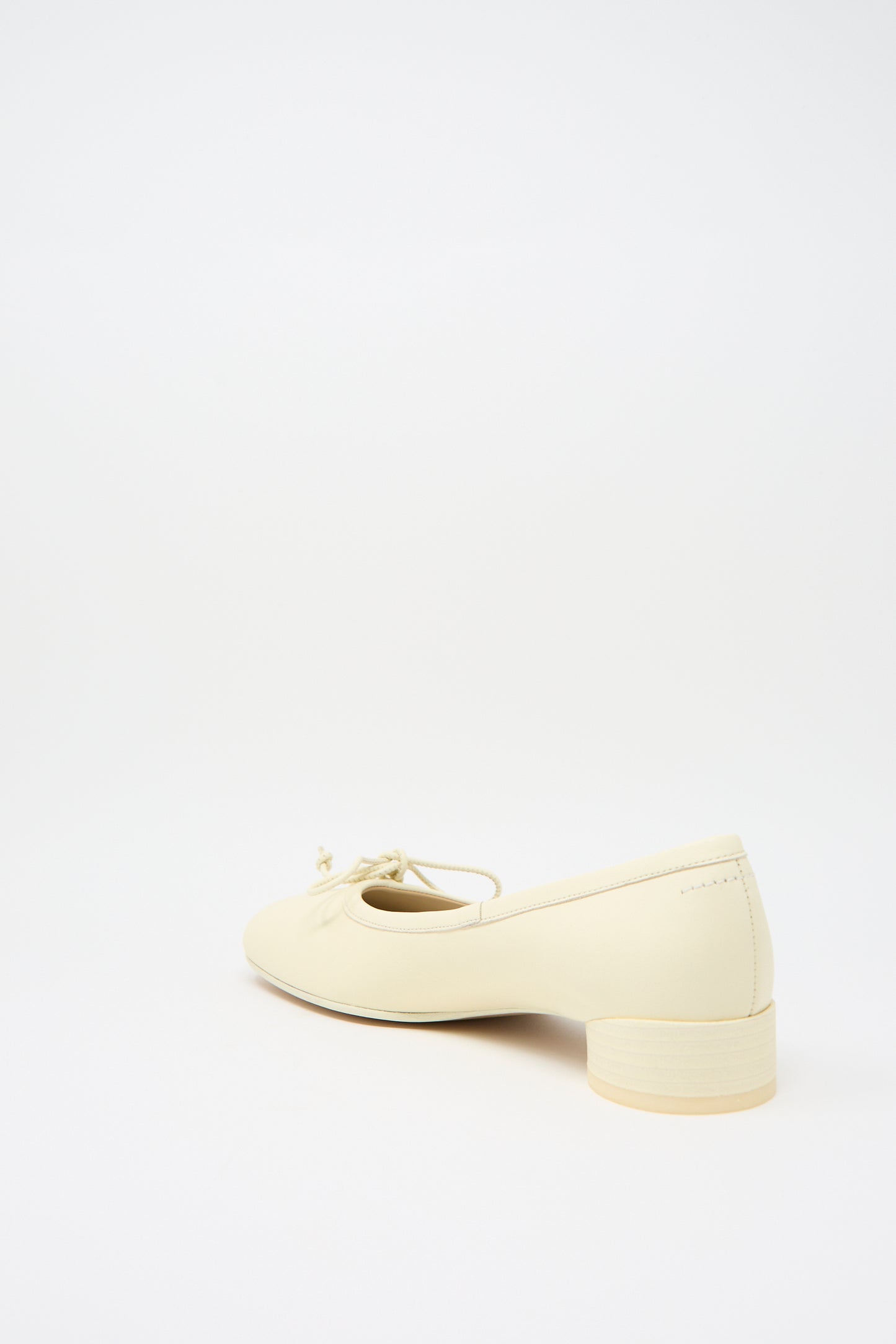 A single MM6 Ballet Shoe in Cream, featuring a small front bow and a cylindrical heel, displayed against a plain white background.