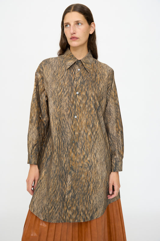 A woman wearing the MM6 Dress in Brown stands against a plain white background.