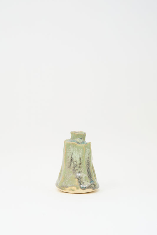 The MONDAYS Carved Bud Vase in Lichen Green features an irregular handmade shape and mottled green and beige glaze, displayed against a plain white background.