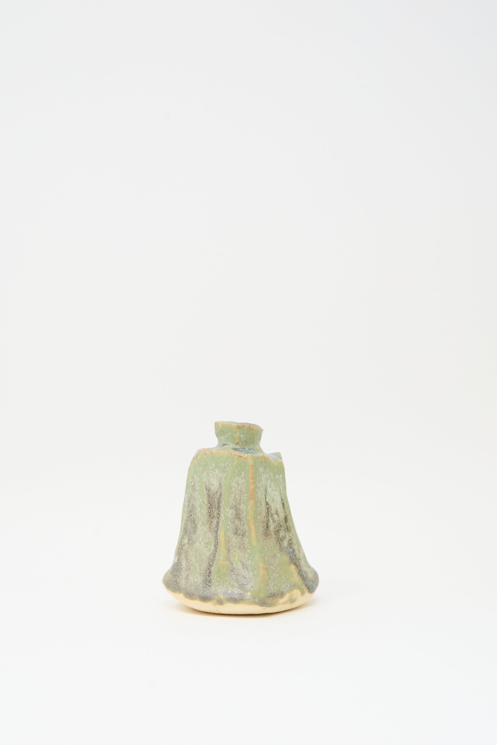 The MONDAYS Carved Bud Vase in Lichen Green features a small, unique handmade form with a green and brown textured finish, photographed on a plain white background. Crafted in Brooklyn.