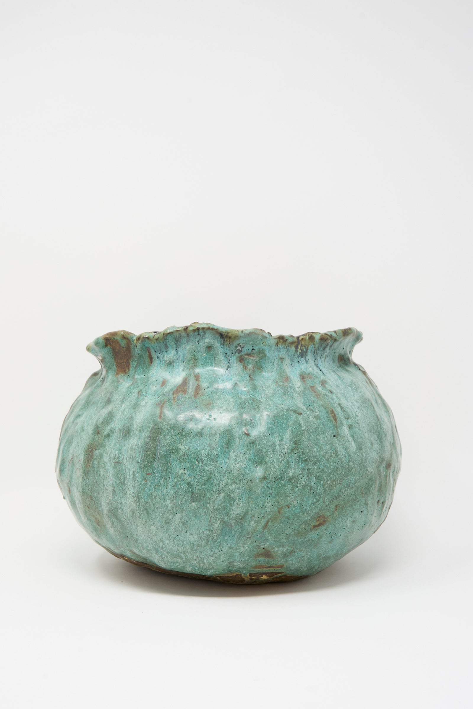 The MONDAYS Coiled Urn in Green is a round stoneware vase with a wavy, uneven rim and textured green-glazed surface, shown against a white background.