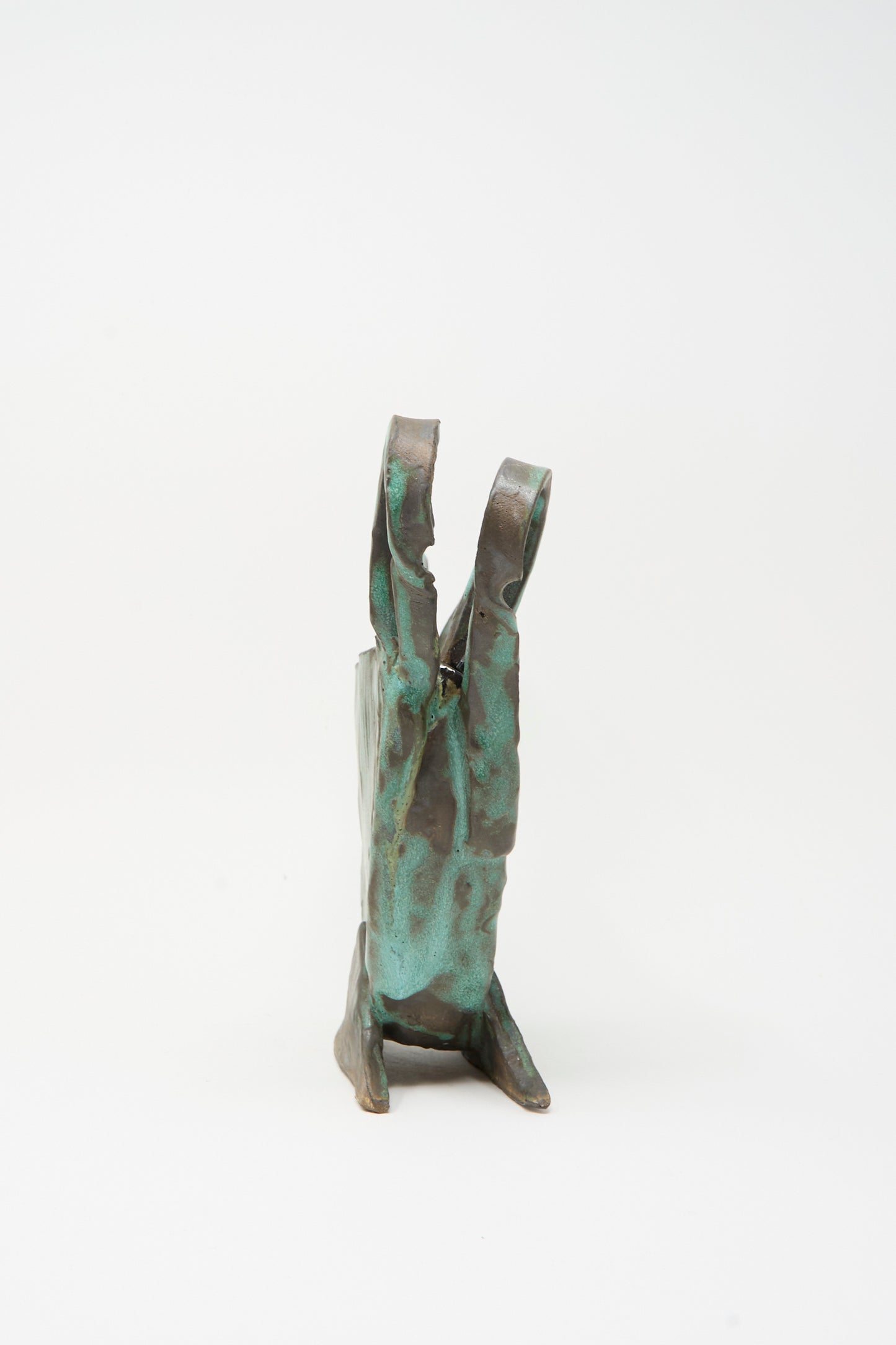 The Corrugated Vessel with Handles in Green by MONDAYS is a handmade ceramic piece featuring bronze and green glaze, textured vertical forms, crafted in Upstate NY, and shown on a white background.