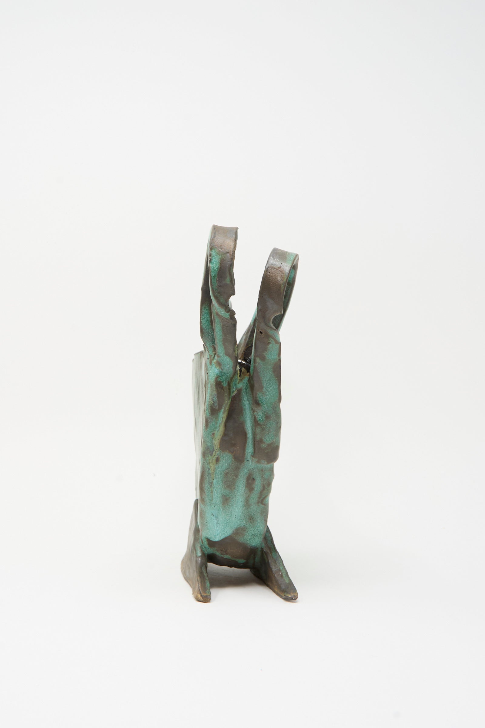 The Corrugated Vessel with Handles in Green by MONDAYS is a handmade ceramic piece featuring bronze and green glaze, textured vertical forms, crafted in Upstate NY, and shown on a white background.