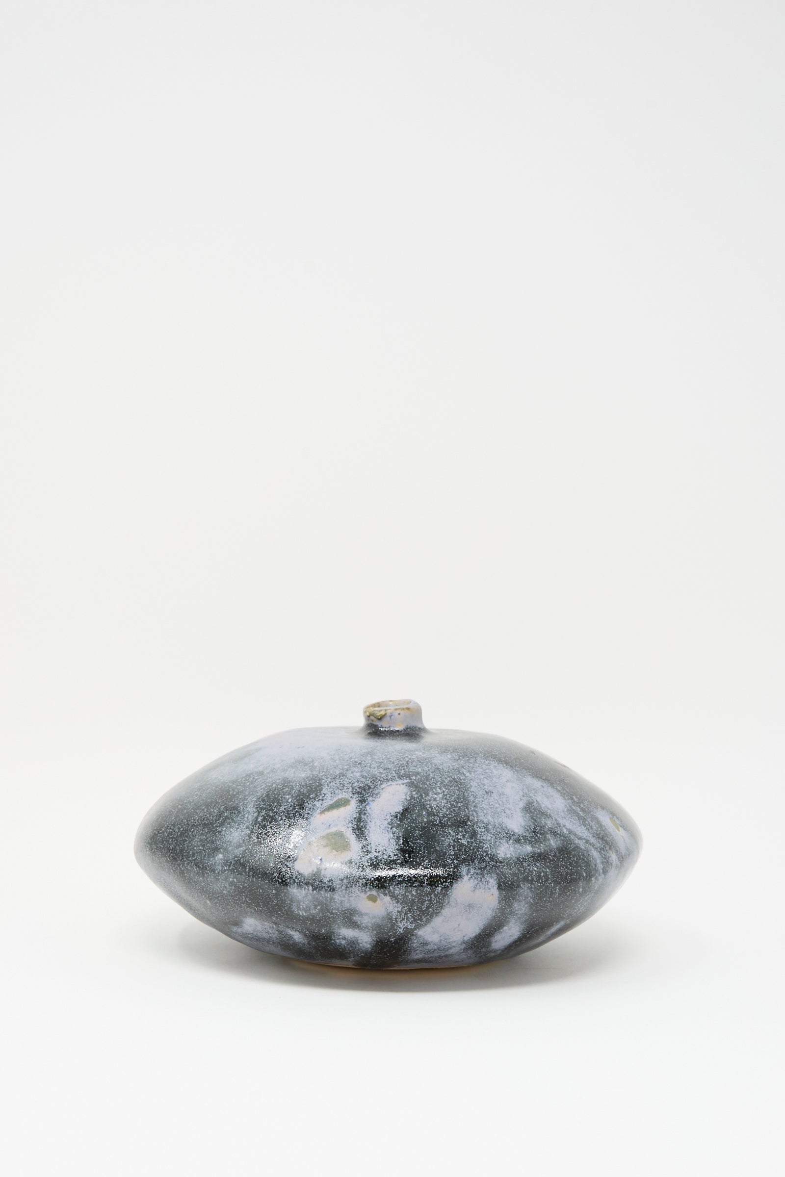The Doyle Vase in Storm by MONDAYS is a rounded, flat handmade vase with a marbled gray and white glaze and a small narrow opening, shown against a plain white background.