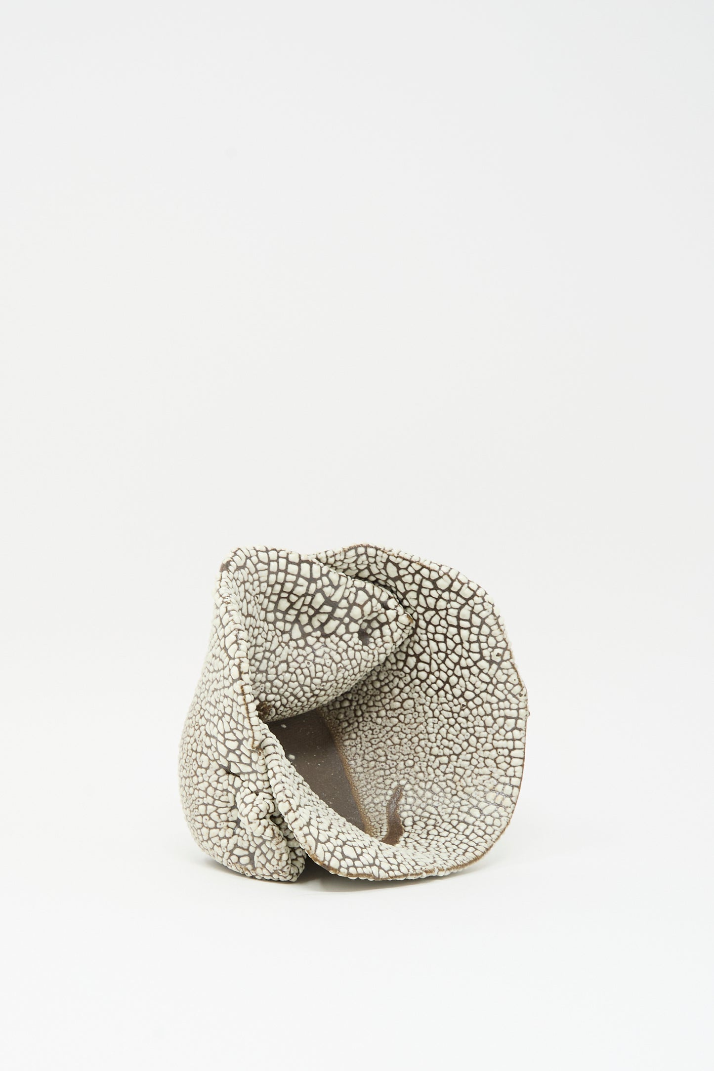 The MONDAYS Folded Bowl in Crawl I features a textured, irregular shape with a cracked white glaze pattern, displayed on a plain white background.