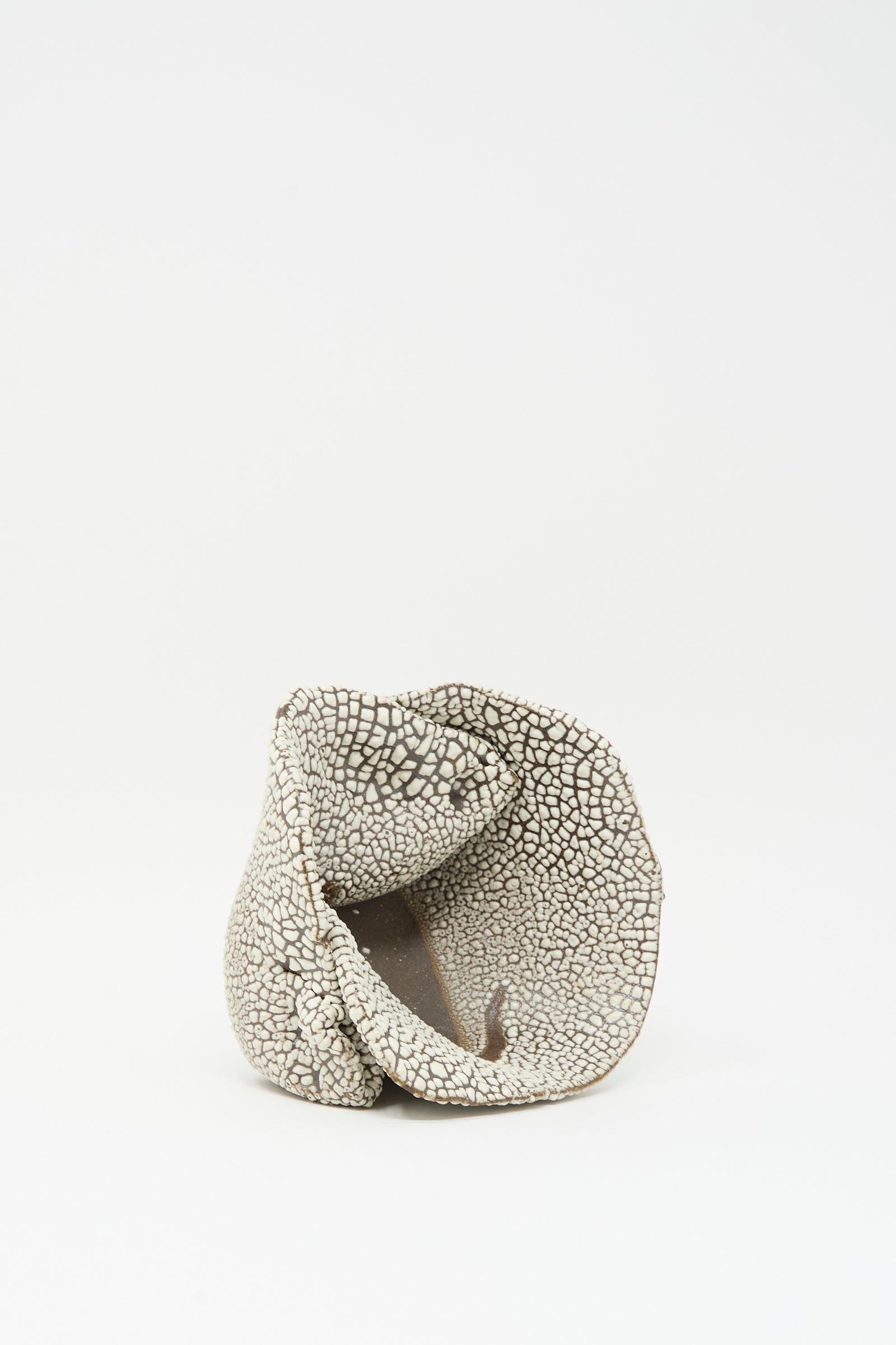 The MONDAYS Folded Bowl in Crawl I features a textured, irregular shape with a cracked white glaze pattern, displayed on a plain white background.