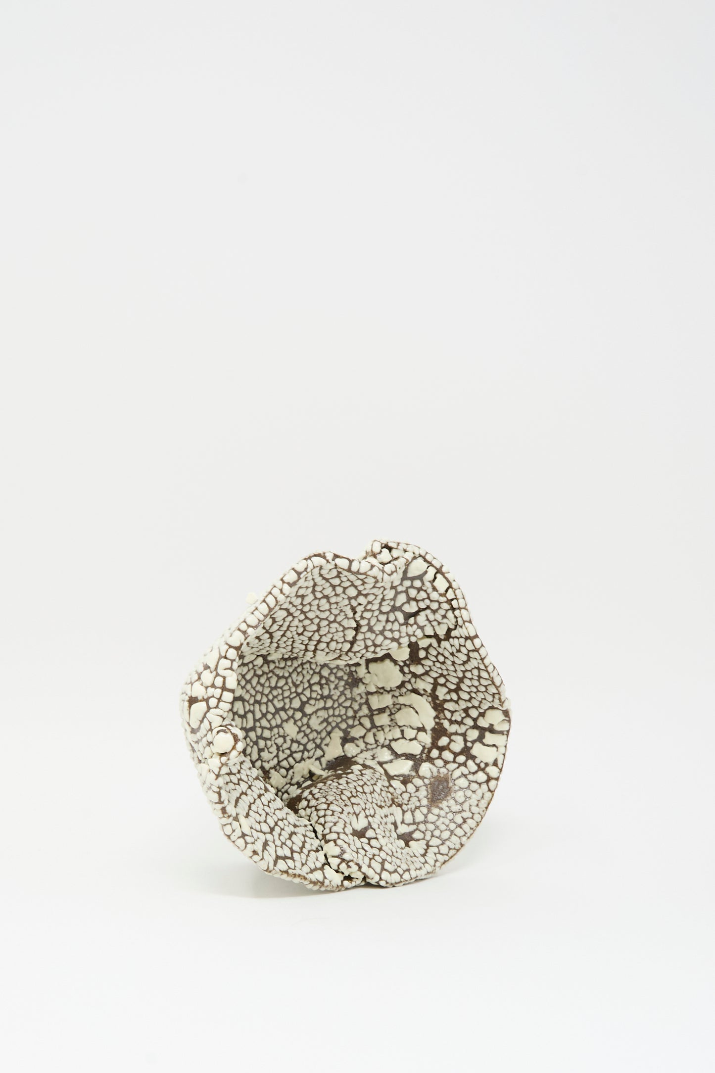 The MONDAYS Folded Bowl in Crawl II is a small, hand-built Brooklyn piece featuring a crackled white glaze and black textured surface, shown on a plain white background.