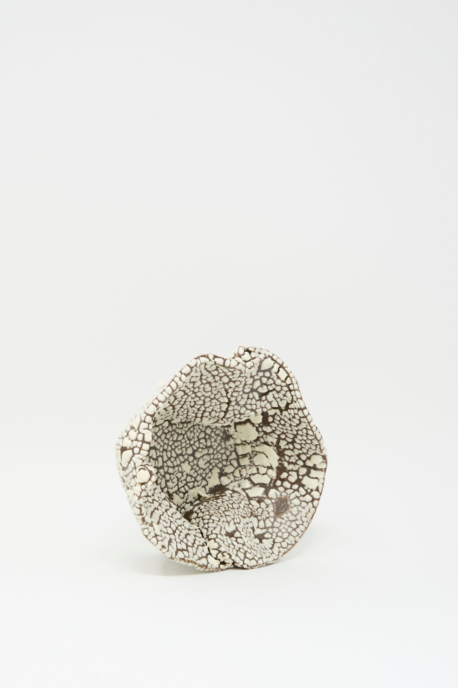 The MONDAYS Folded Bowl in Crawl II is a small, hand-built Brooklyn piece featuring a crackled white glaze and black textured surface, shown on a plain white background.