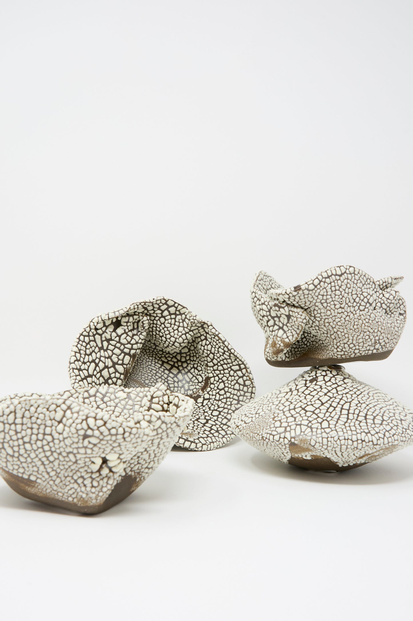 The MONDAYS Folded Bowl in Crawl II features a hand-built, irregular form with a cracked white glaze, showcasing Brooklyn ceramic artistry against a plain white background.