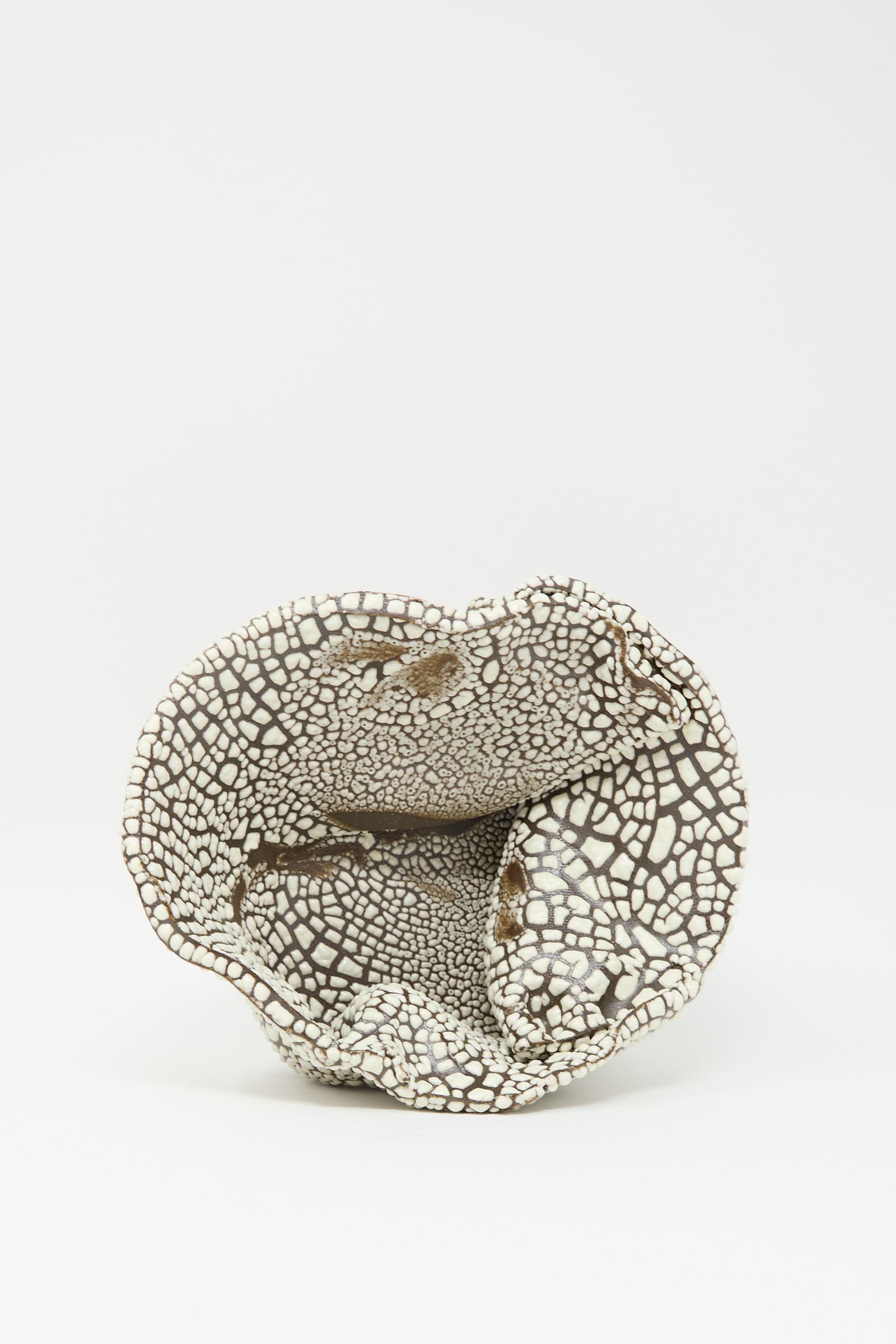 The MONDAYS Folded Bowl in Crawl III is hand-built in Brooklyn, featuring an irregular wavy rim and a textured surface with a cracked, brown-and-white mosaic glaze.