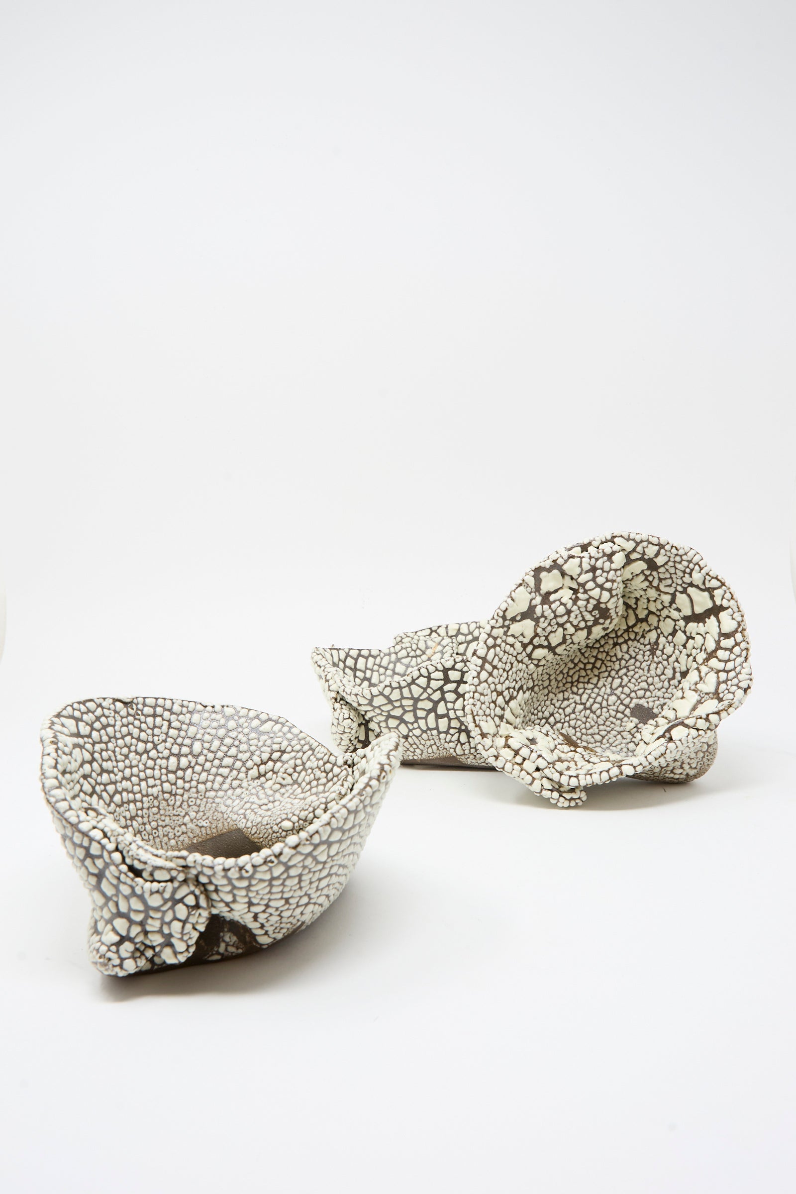The MONDAYS Folded Wavy Bowl in Crawl II features abstract, textured ceramic design with a crawling white glaze, artfully displayed on a plain white background and inspired by hand-built Brooklyn bowls.