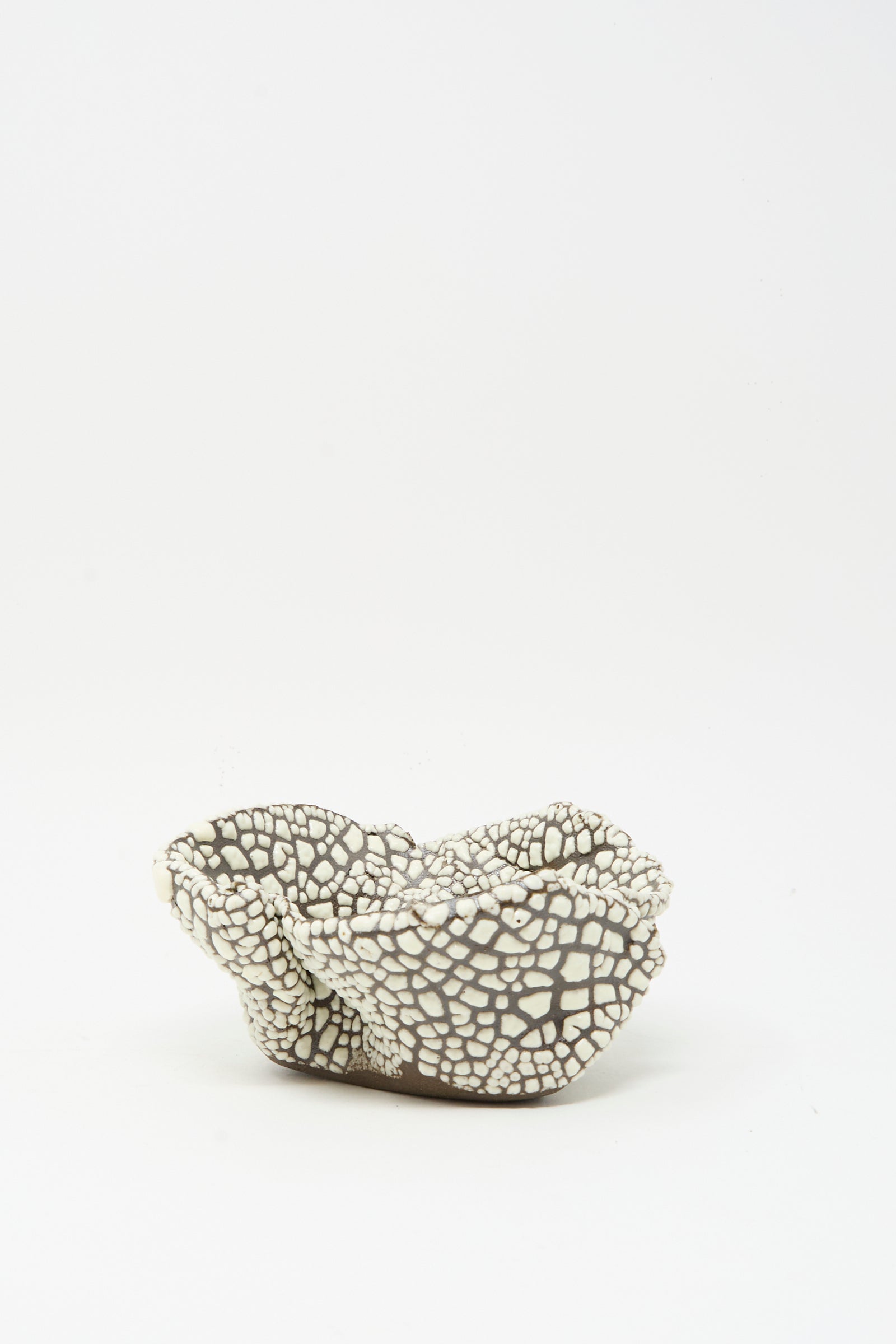 The MONDAYS Folded Wavy Bowl in Crawl IV is a small, hand-built gray bowl with a textured crawling white glaze, displayed on a plain white background.