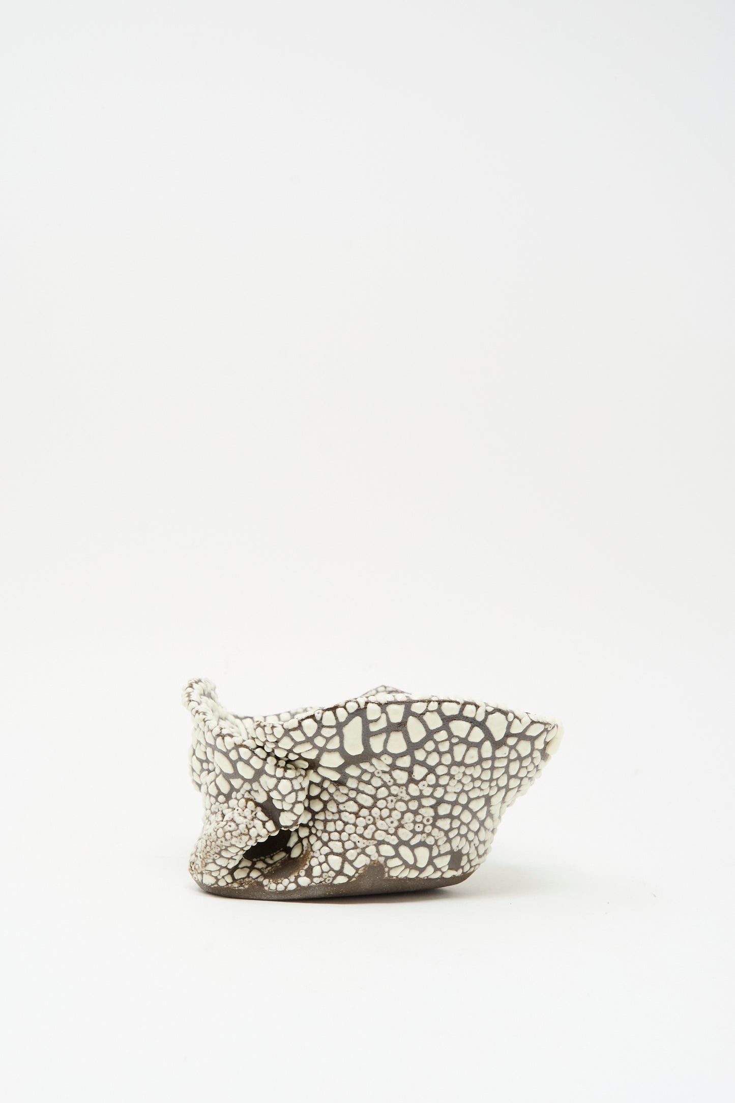 The MONDAYS Folded Wavy Bowl in Crawl IV, a hand-built piece with a crackled brown and crawling white glaze, features an irregular form and sits on a plain white background.