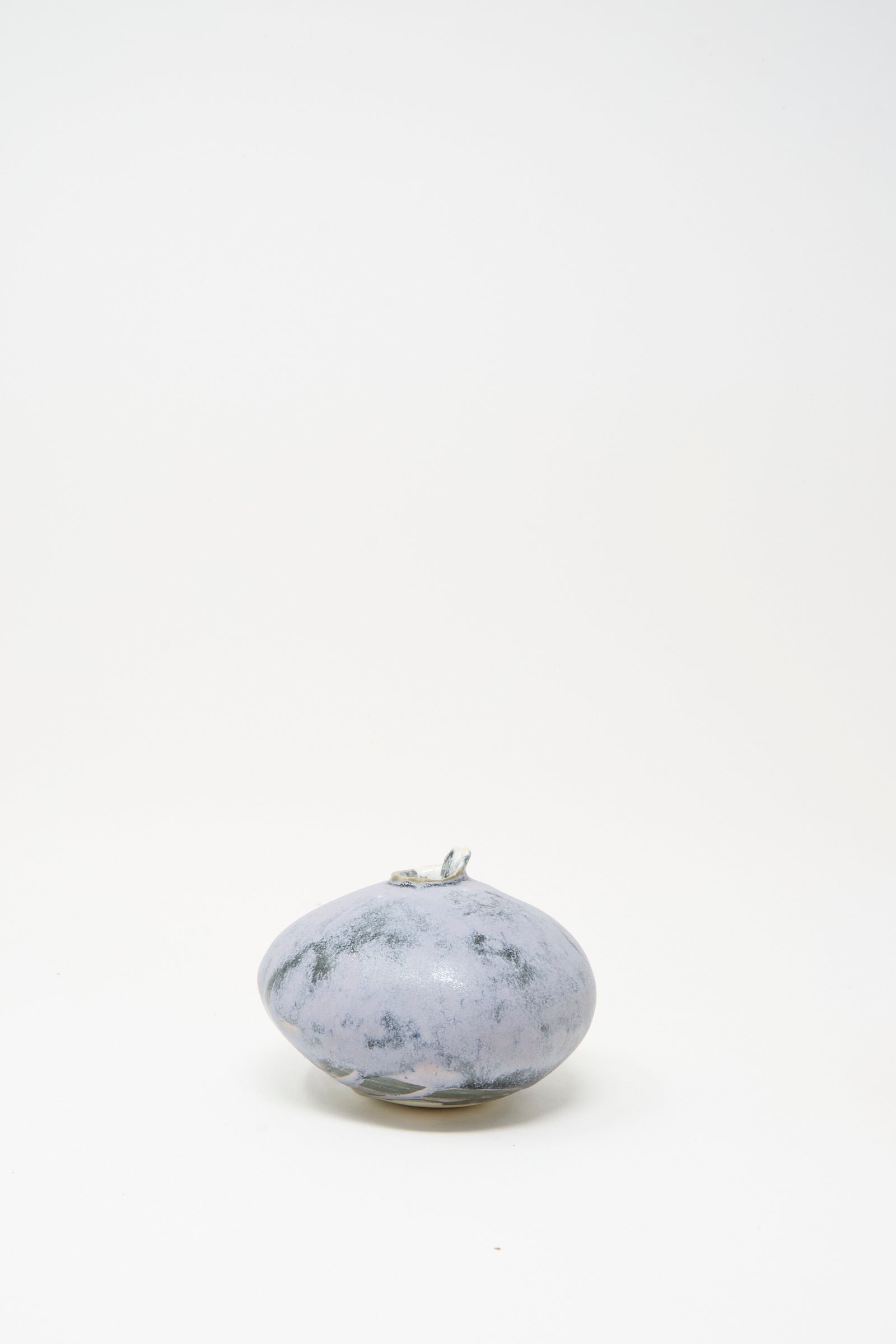 The MONDAYS Mini Moon Vase in Blue features a round, smooth, marbled grayish surface and sits on a white background, evoking the artisanal charm of Upstate NY pottery.