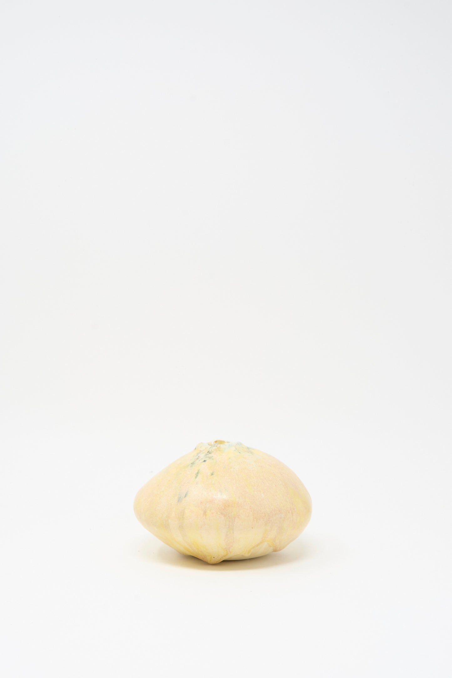 A Mini Moon Vase in Yellow Multi by MONDAYS is displayed beside a round yellow squash against a plain white background.